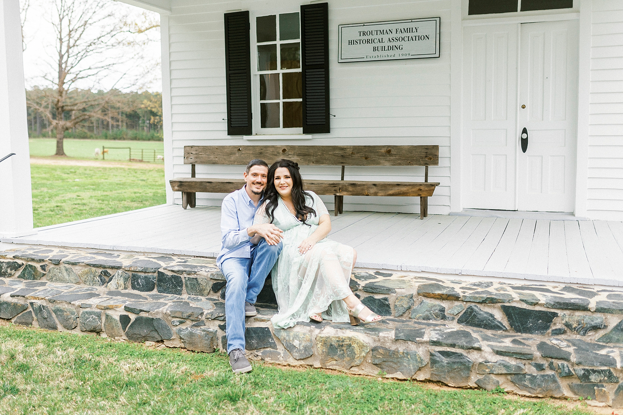 bride and groom sit on stone steps during White Chapel engagement session