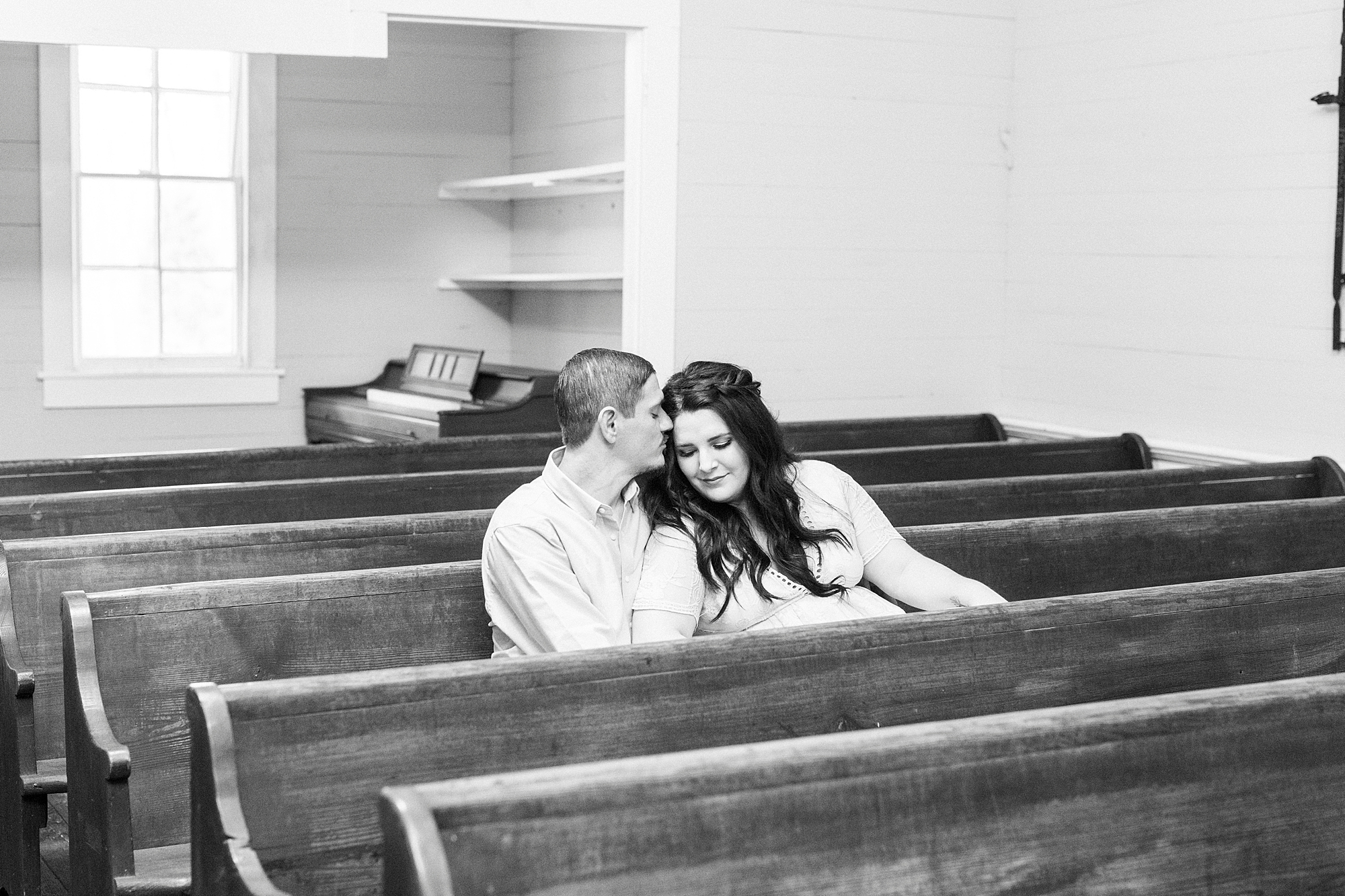 bride and groom sit in pews of family's chapel