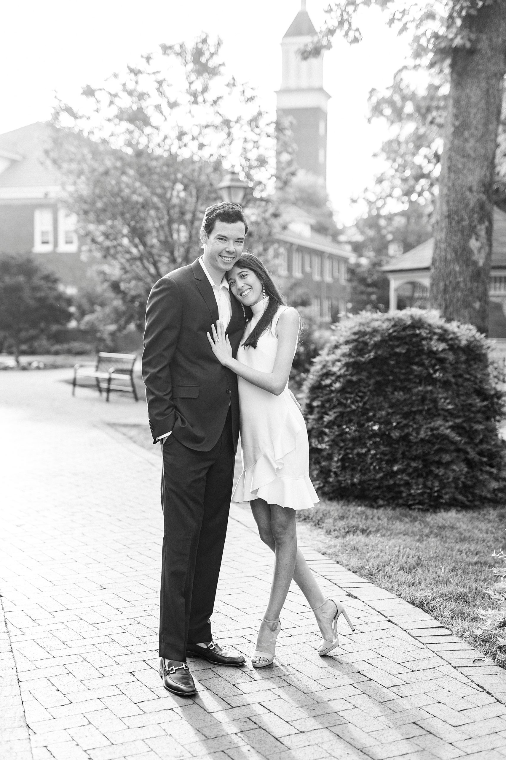 bride leans into groom's chest during Queens University engagement session