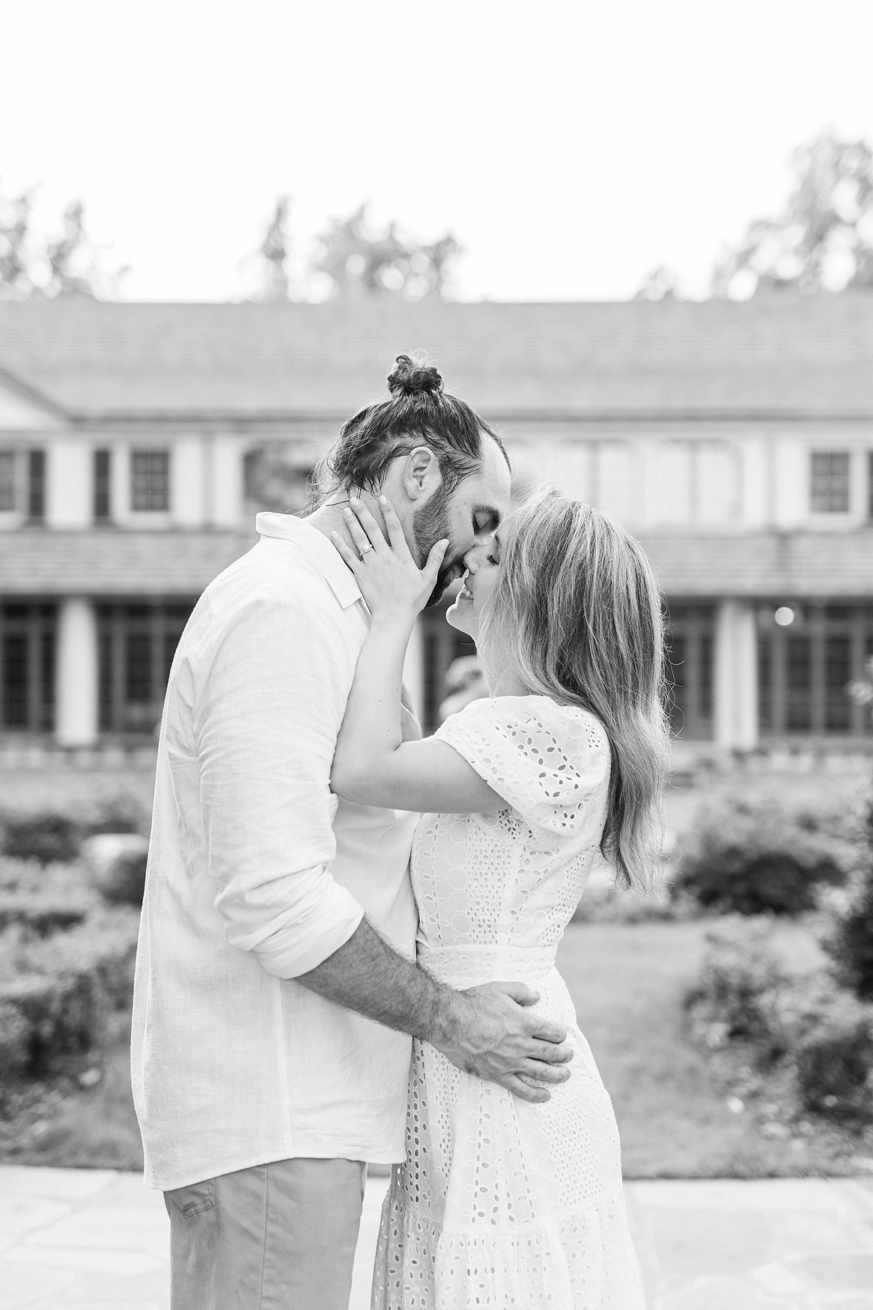 black and white portrait of couple kissing at Reynolda Gardens