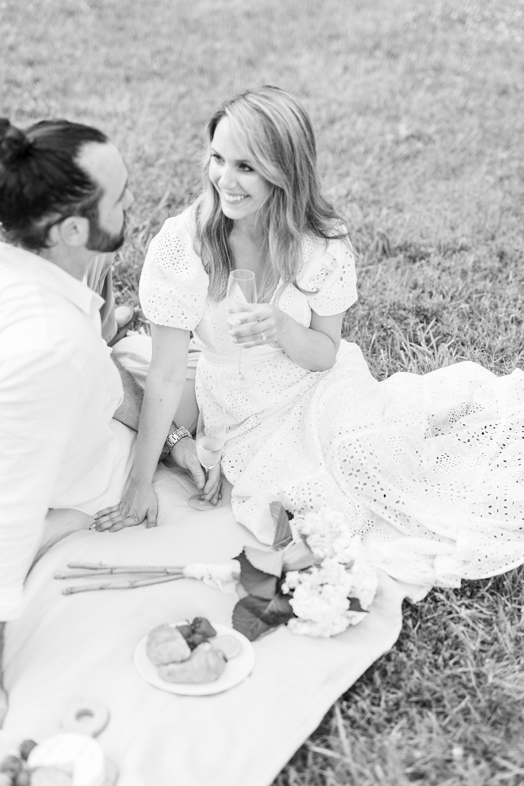 couple chats during picnic at engagement session