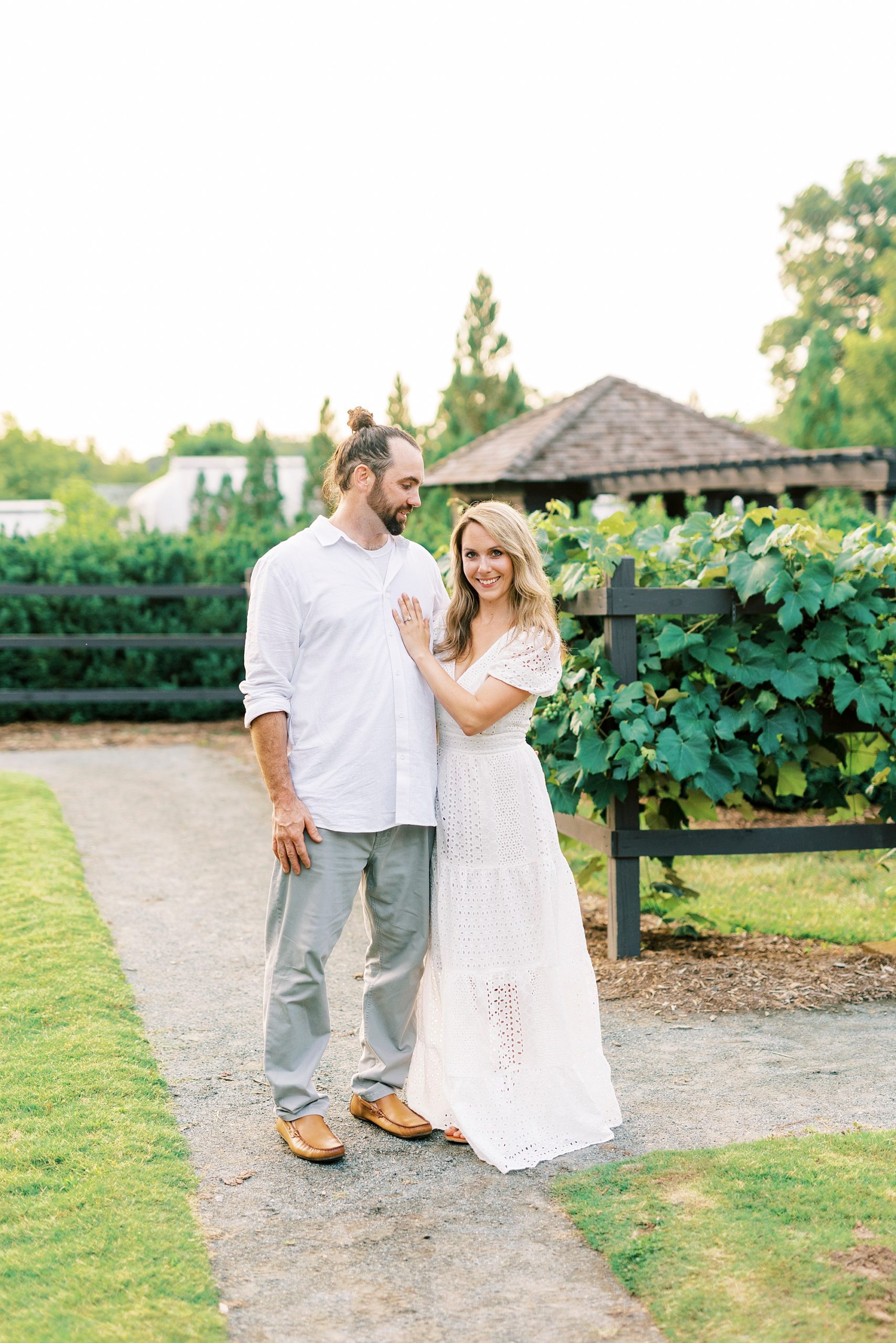 bride and groom stand together on lawn at Reynolda Gardens
