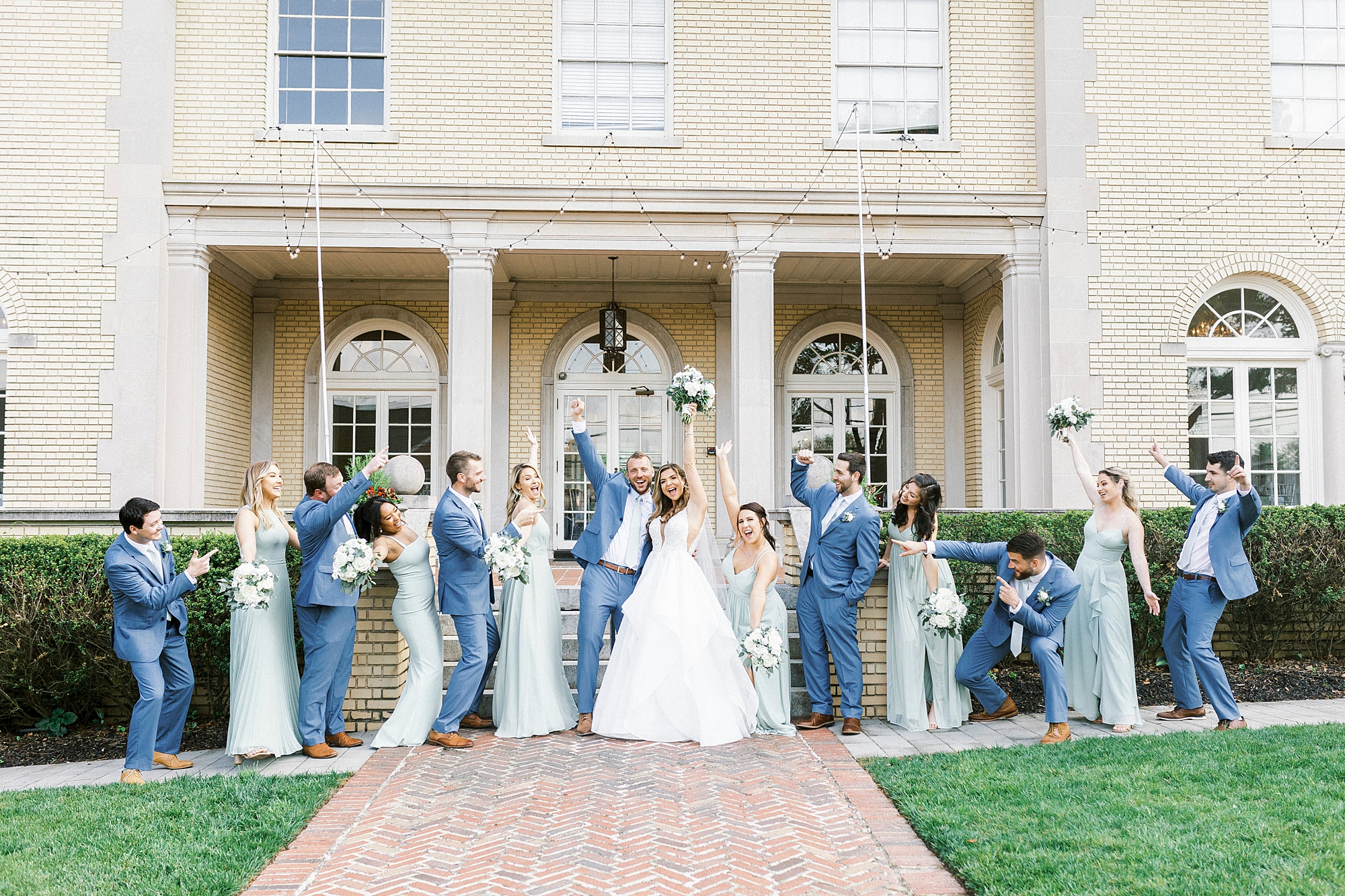 newlyweds cheer during spring wedding portraits at Separk Mansion
