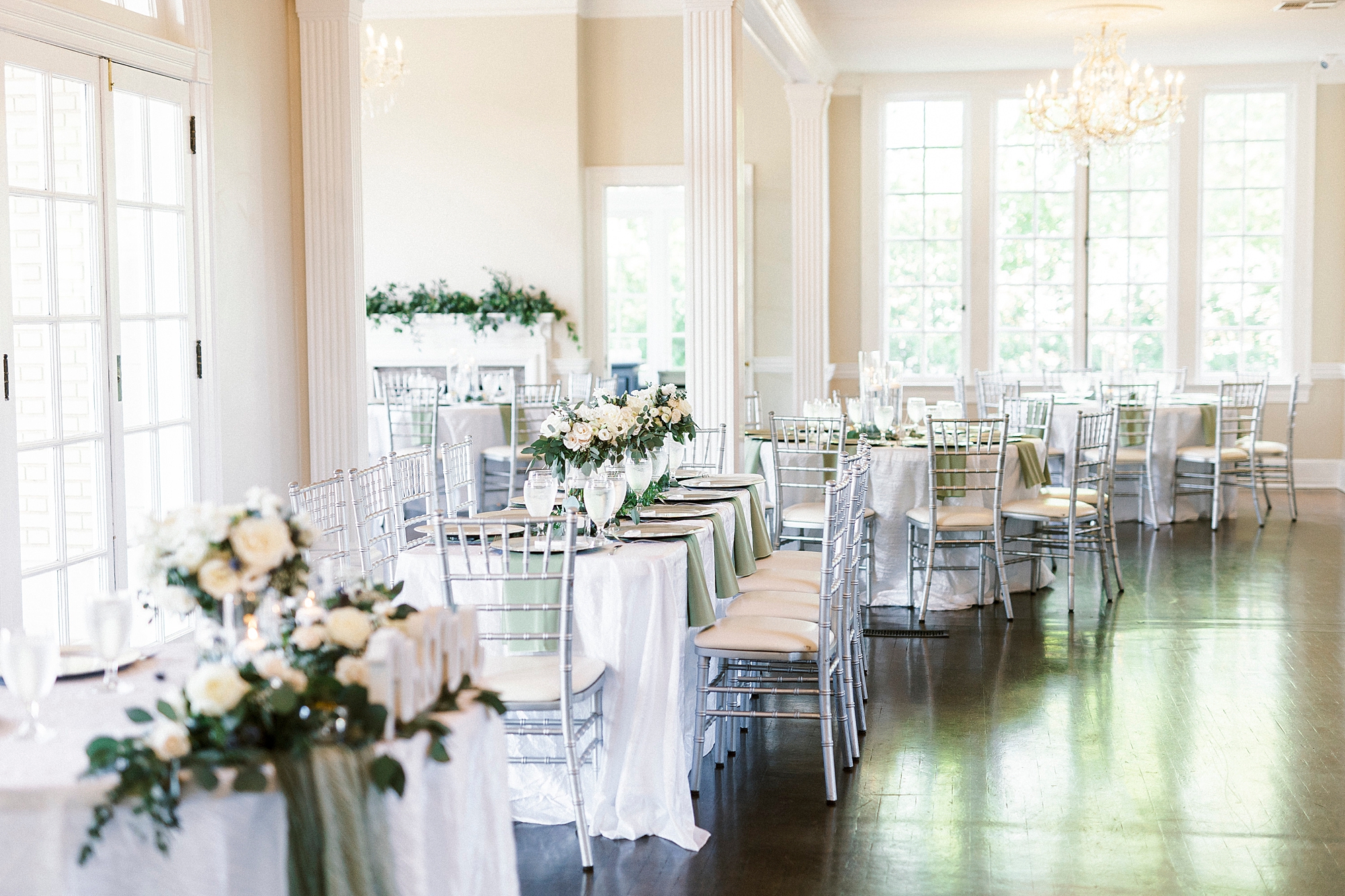 wedding reception with ivory roses and greenery details