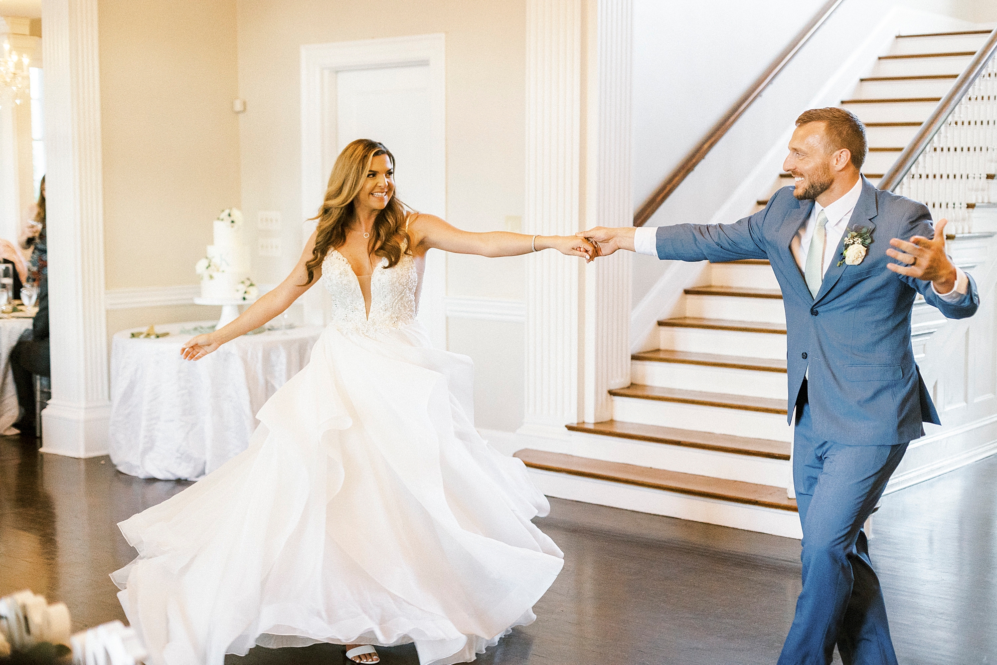 groom twirls bride during wedding dances