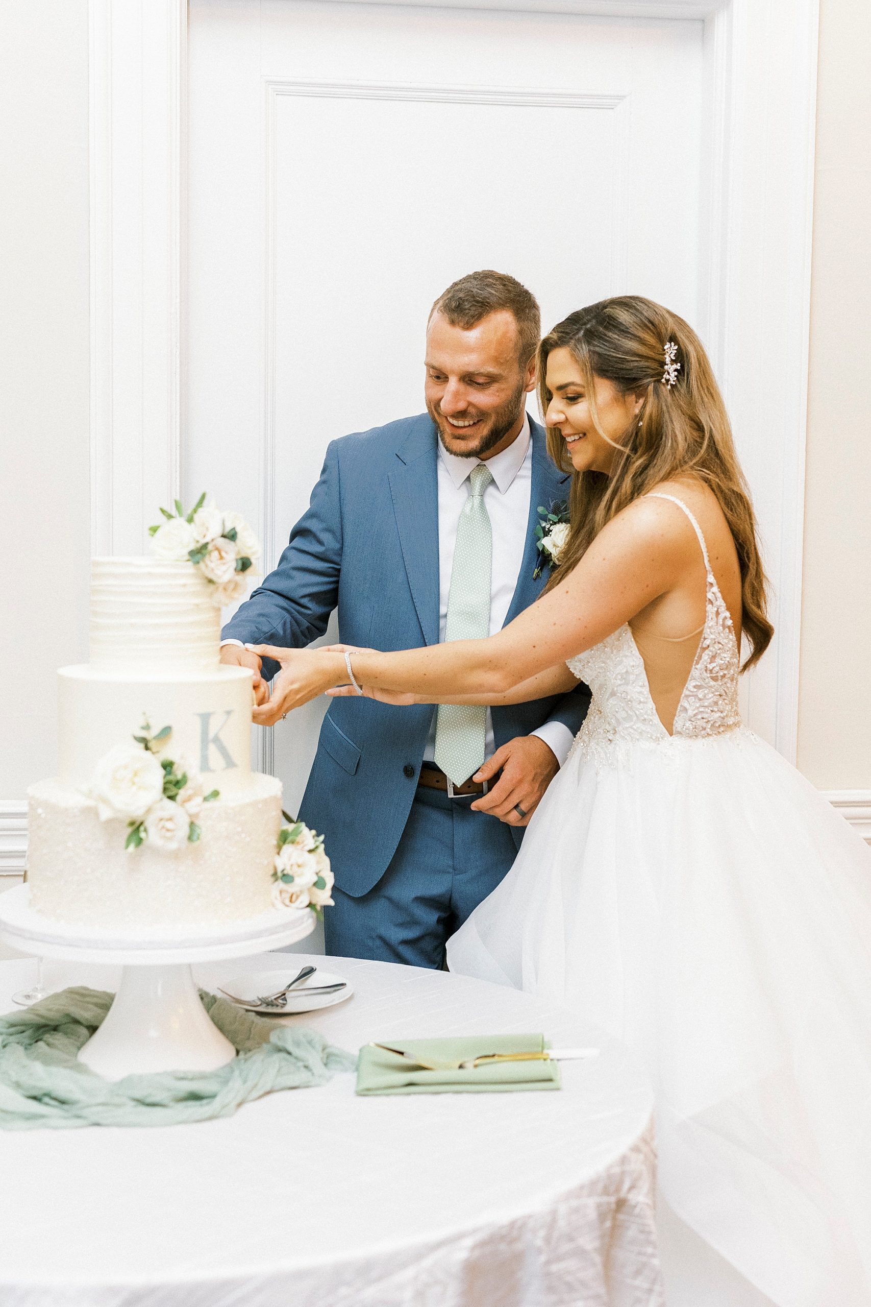 bride and groom cut wedding cake during Gastonia wedding reception