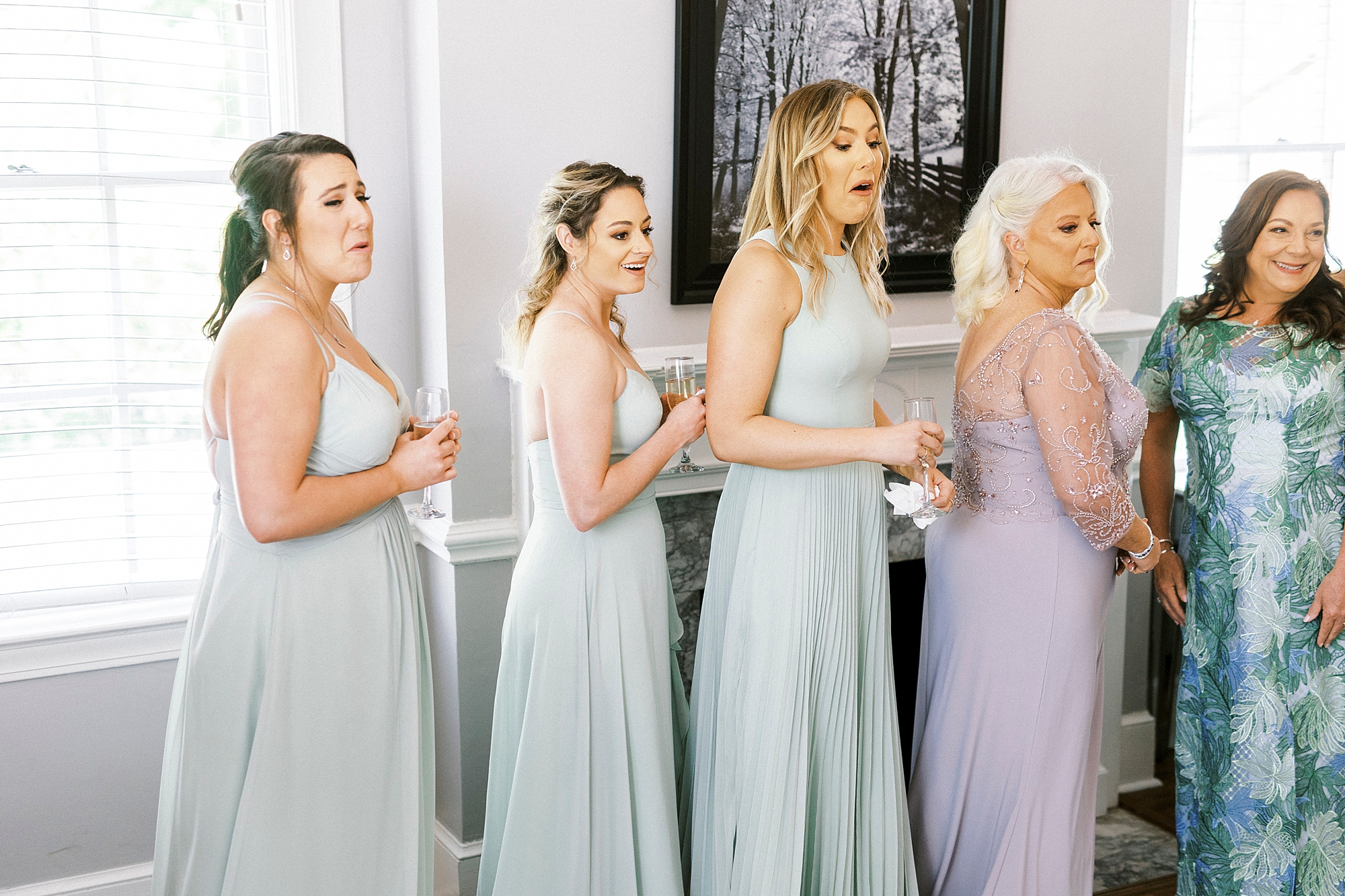 bridesmaids react to seeing bride in wedding gown