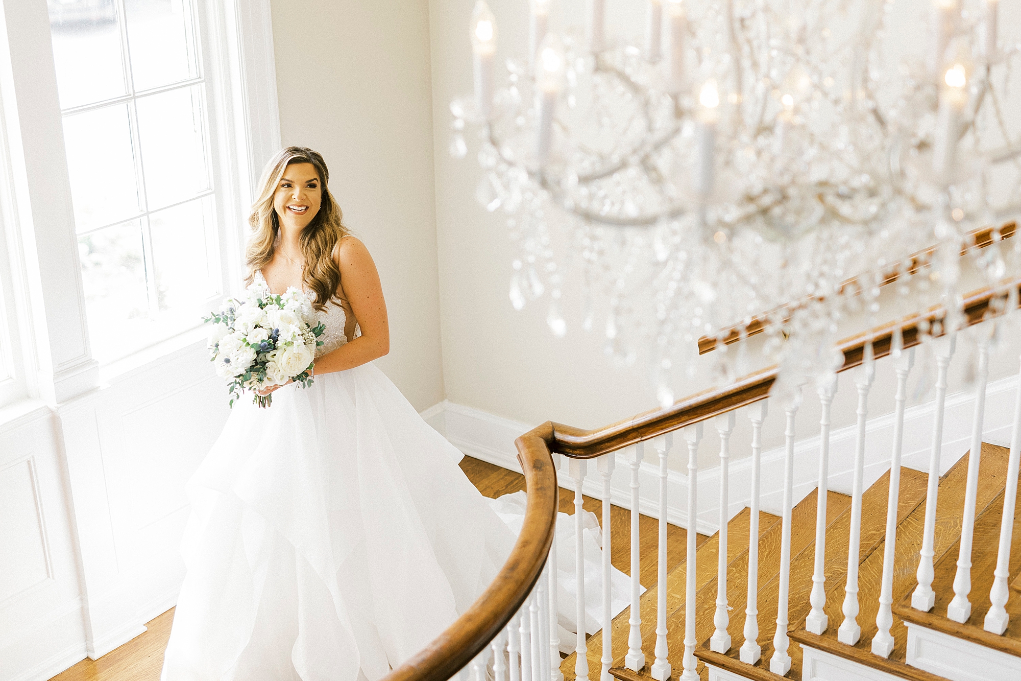 bride poses on staircase in Separk Mansion