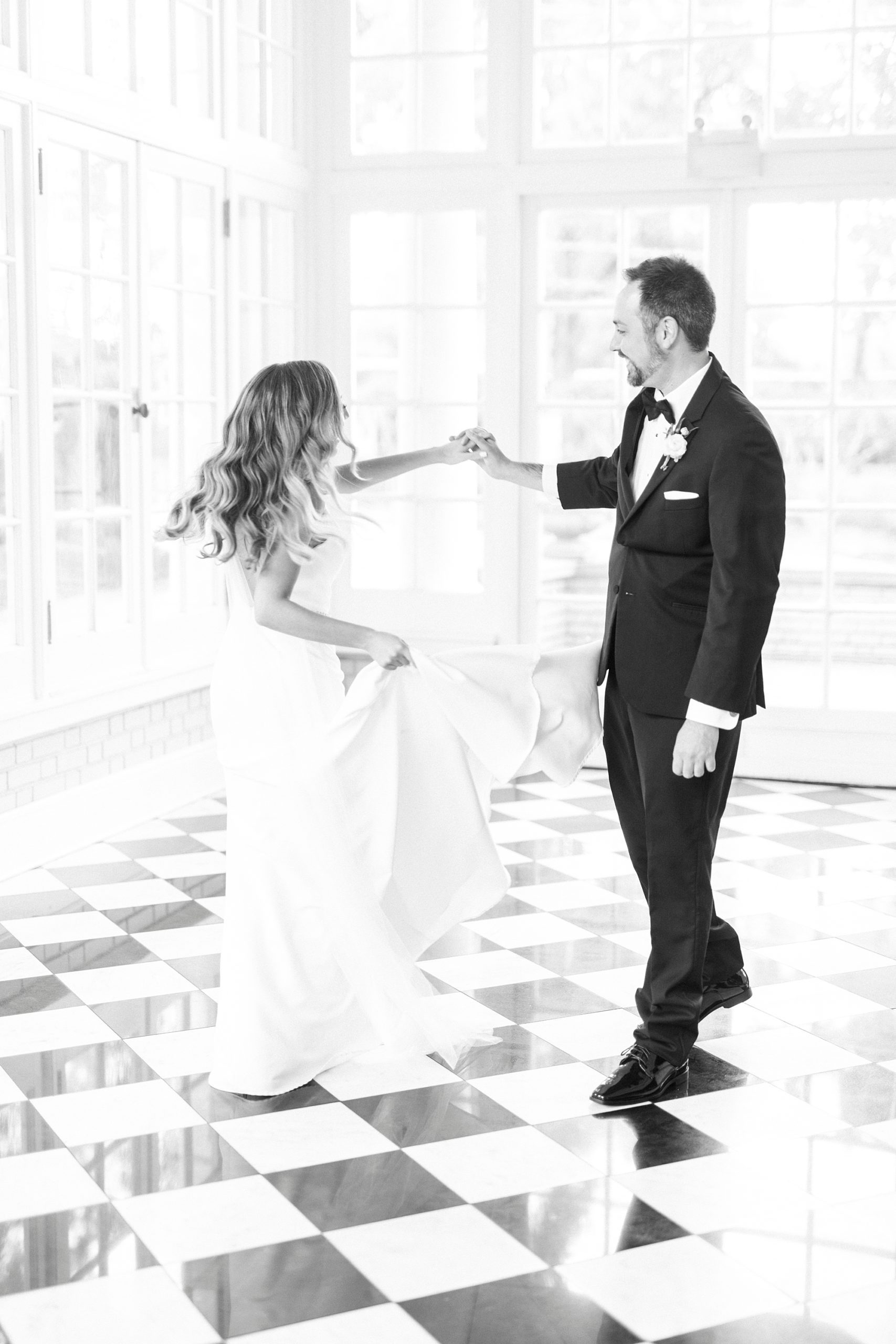 newlyweds dance in sunroom with black and white floor at Separk Mansion