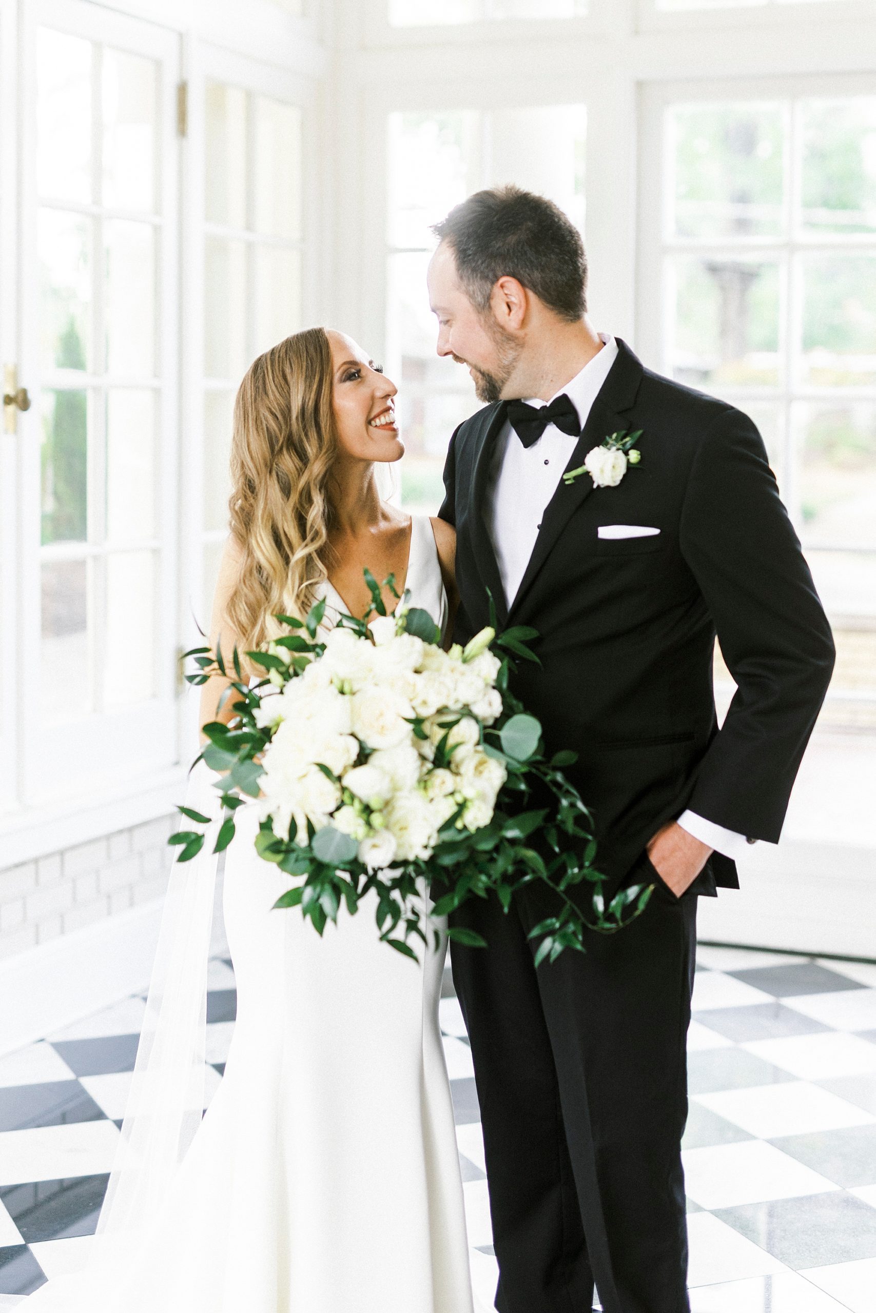 bride and groom smile together in sunroom at Separk Mansion