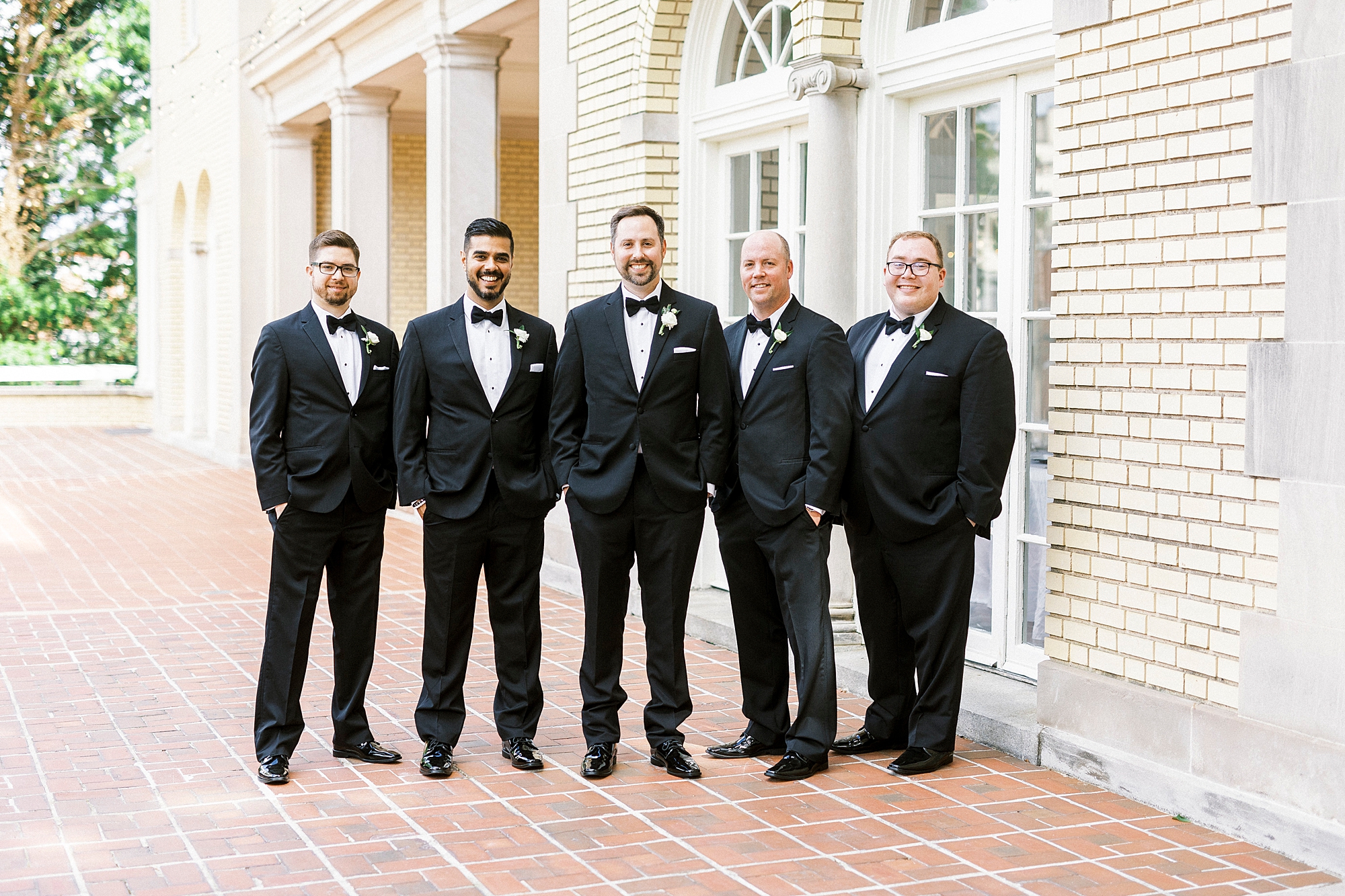 groom and groomsmen pose together in classic black suits at Separk Mansion