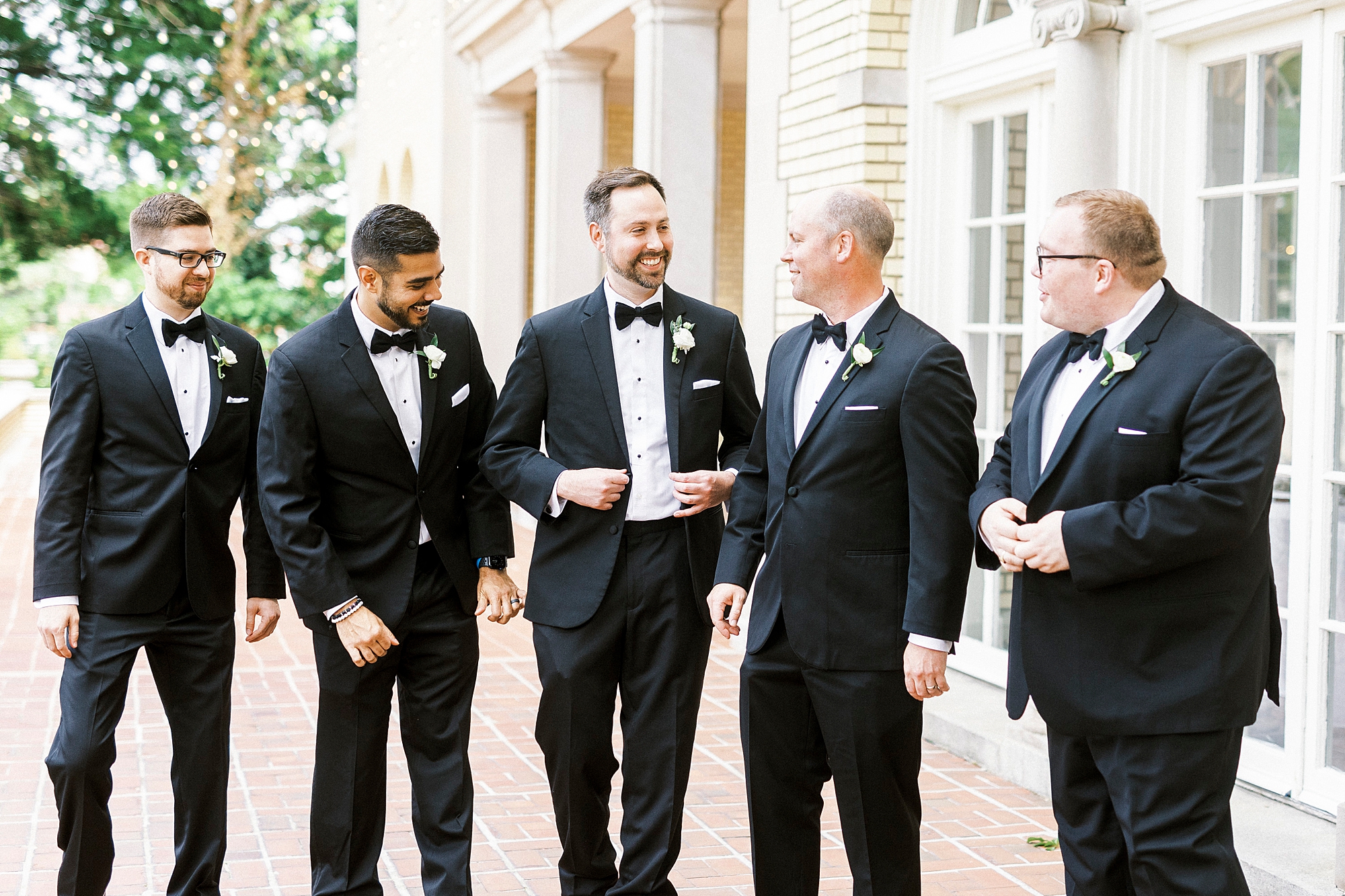 groom walks with groomsmen in classic suits in Gastonia NC