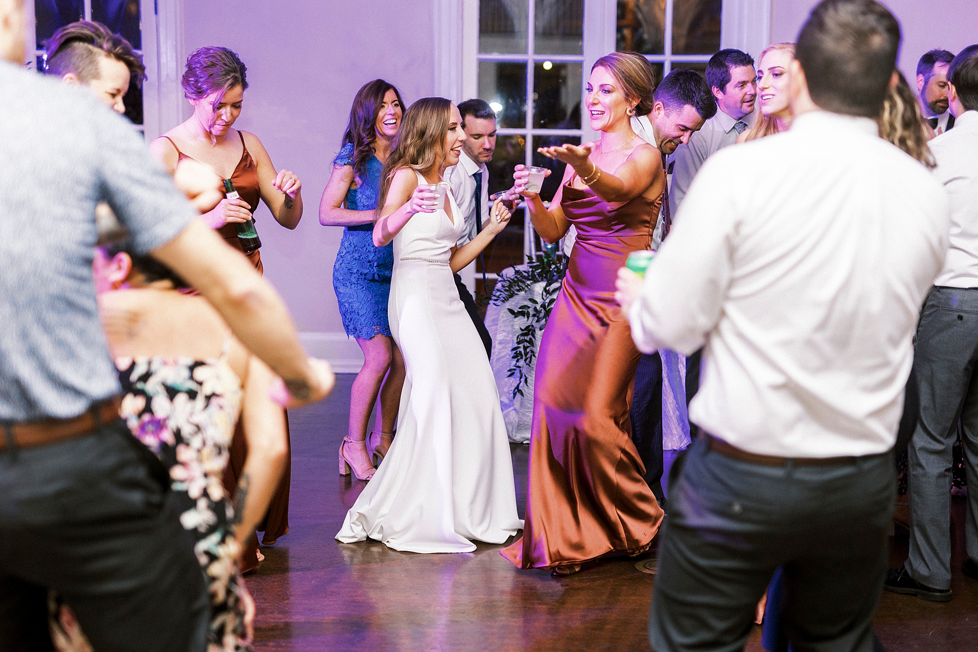 bride dances with bridesmaids during NC wedding reception