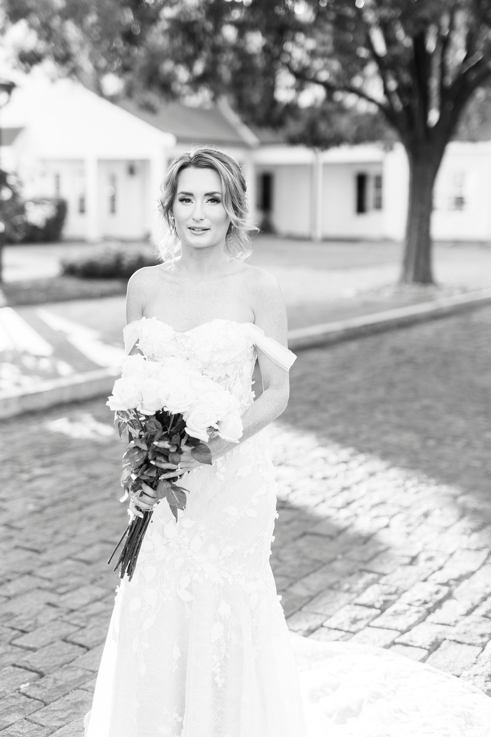 black and white portrait of bride holding white bouquet at Trump National Golf Club