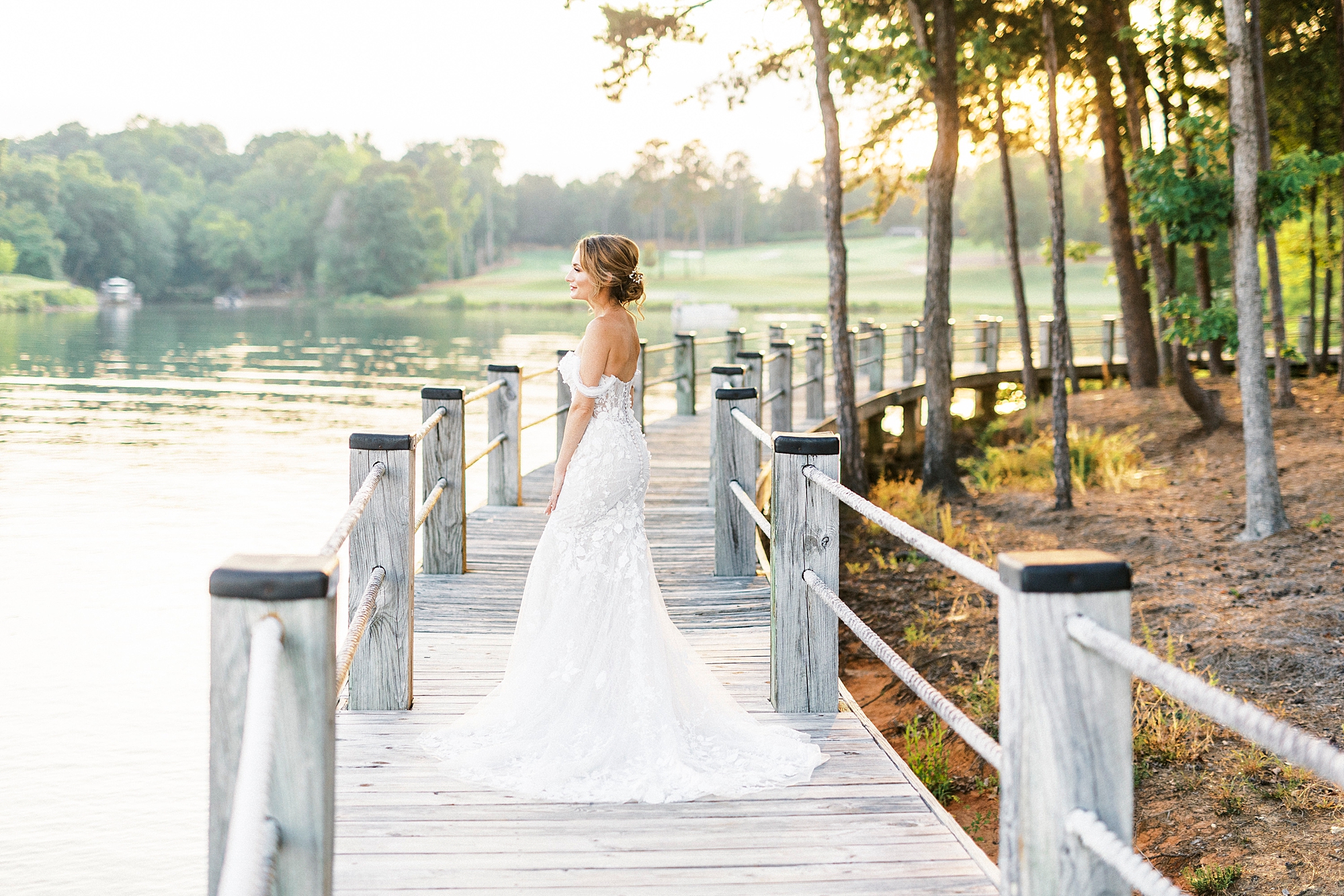 bride walks on wooden walkway at Trump National Golf Club