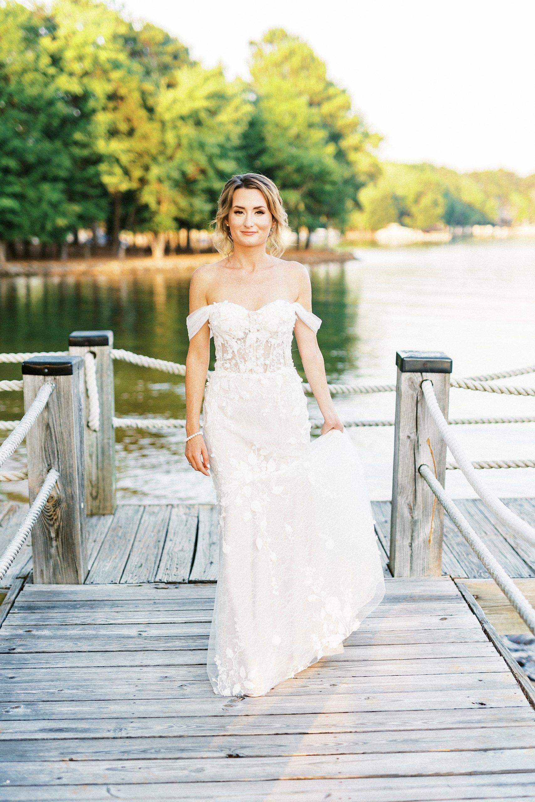 bride walks down dock during session at Trump National Golf Club