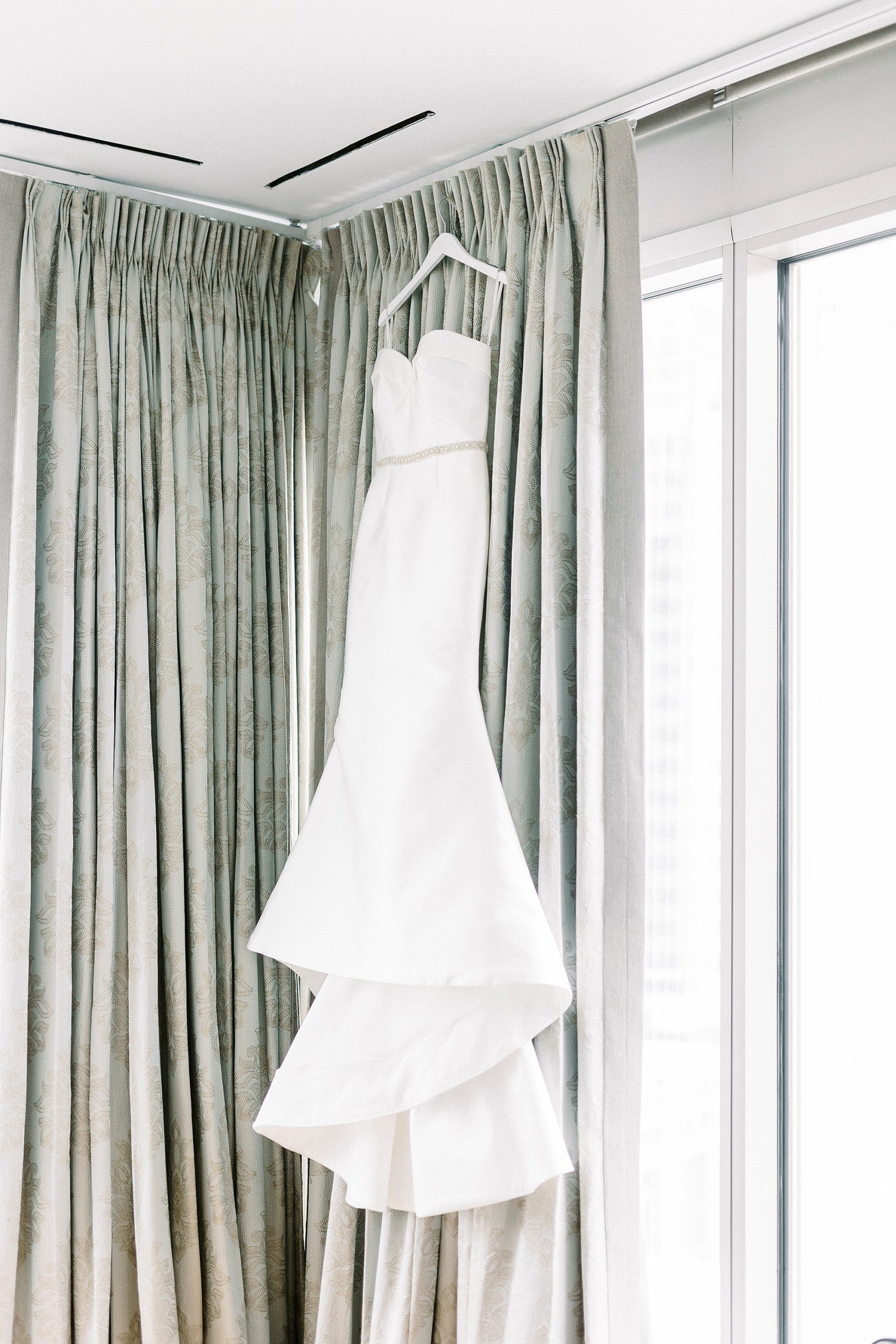 bride's dress hangs in window at Kimpton Tyron Park