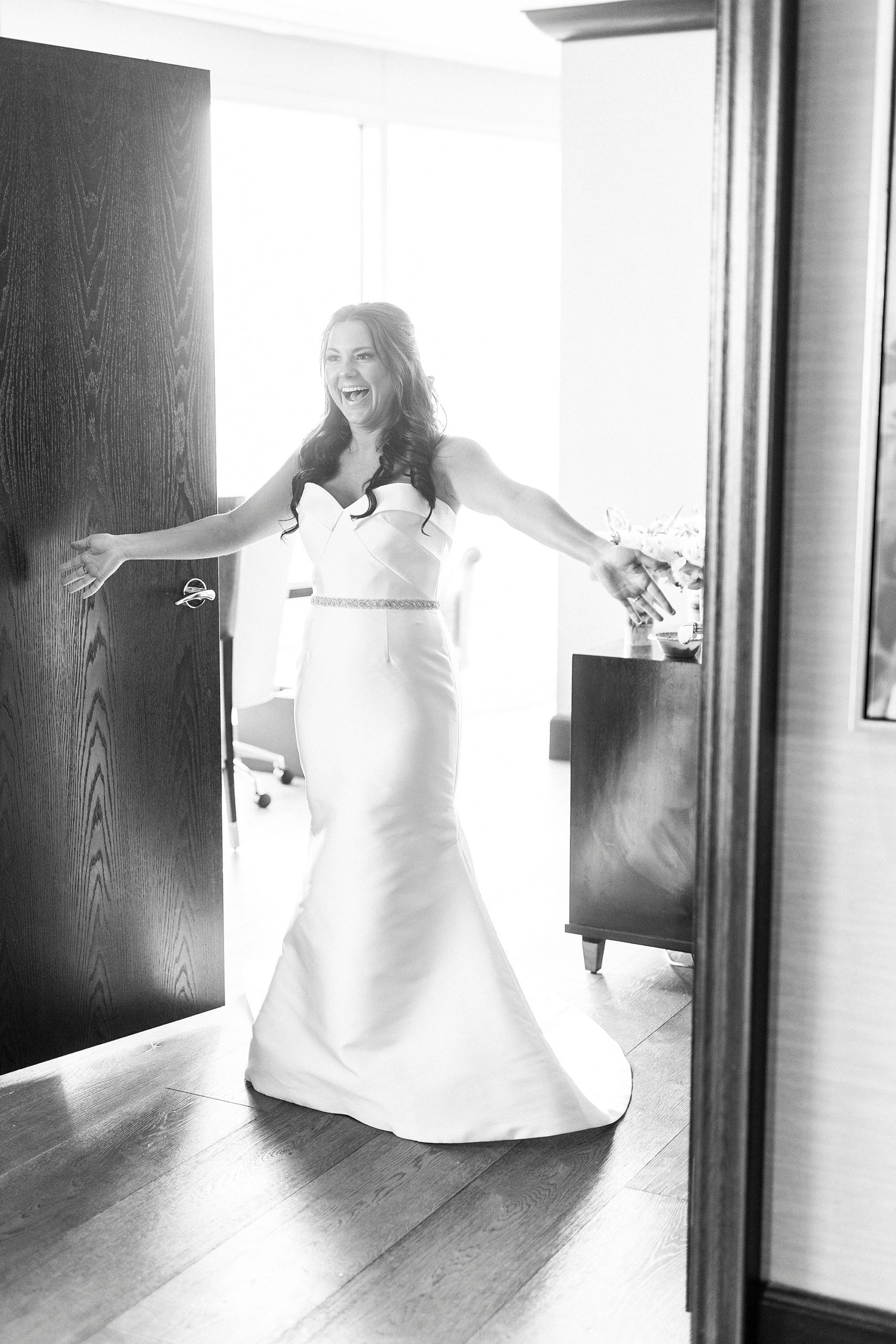bride walks into room with bridesmaids for first look at Kimpton Tyron Park
