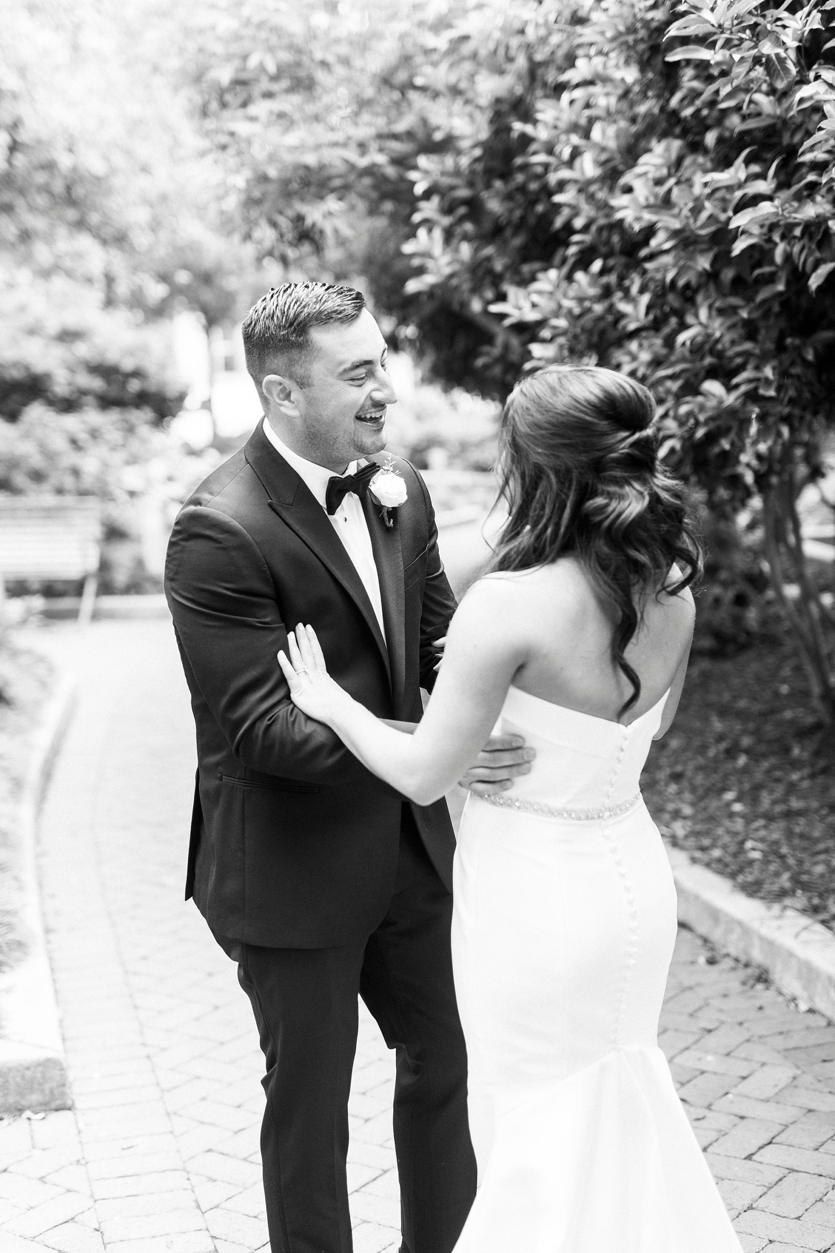 newlyweds hug during first look in Charlotte NC park