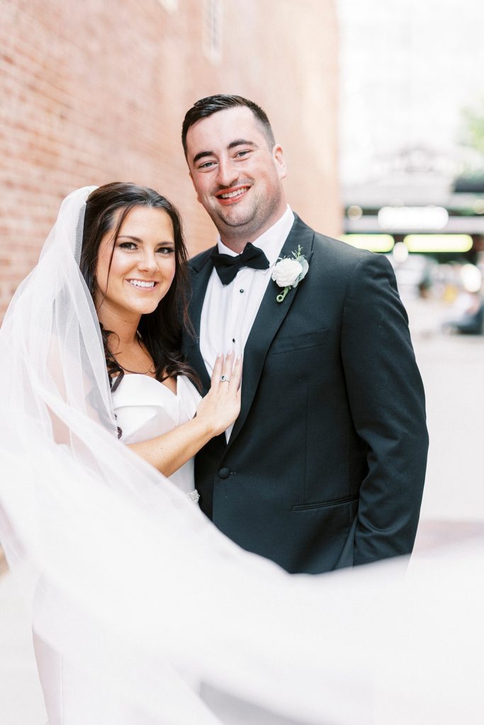 bride and groom pose in alleyway at Byron's South End