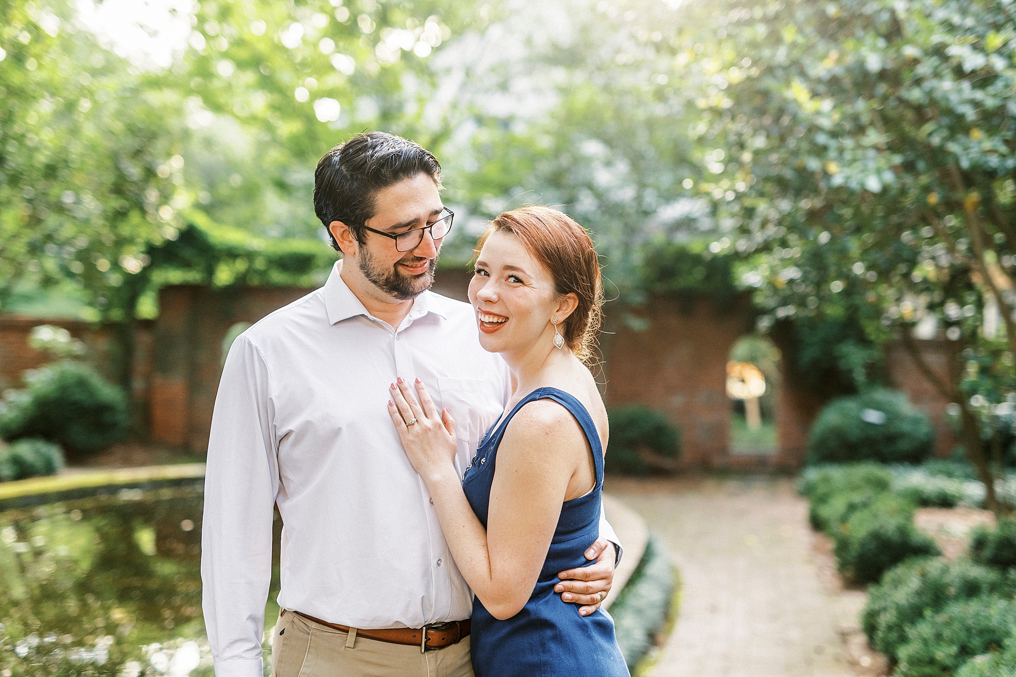married couple hugs in garden during anniversary photos 