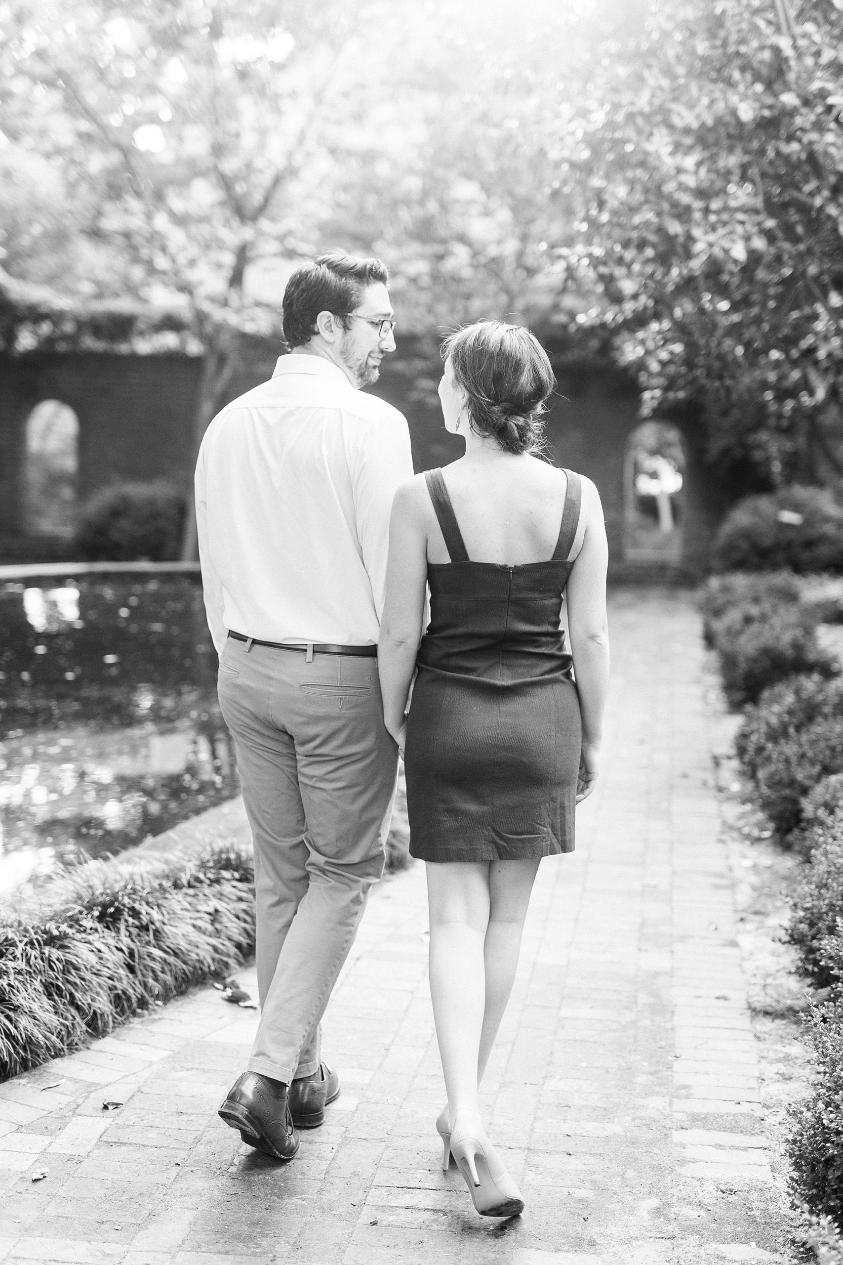 married couple holds hands walking through Wing Haven Garden
