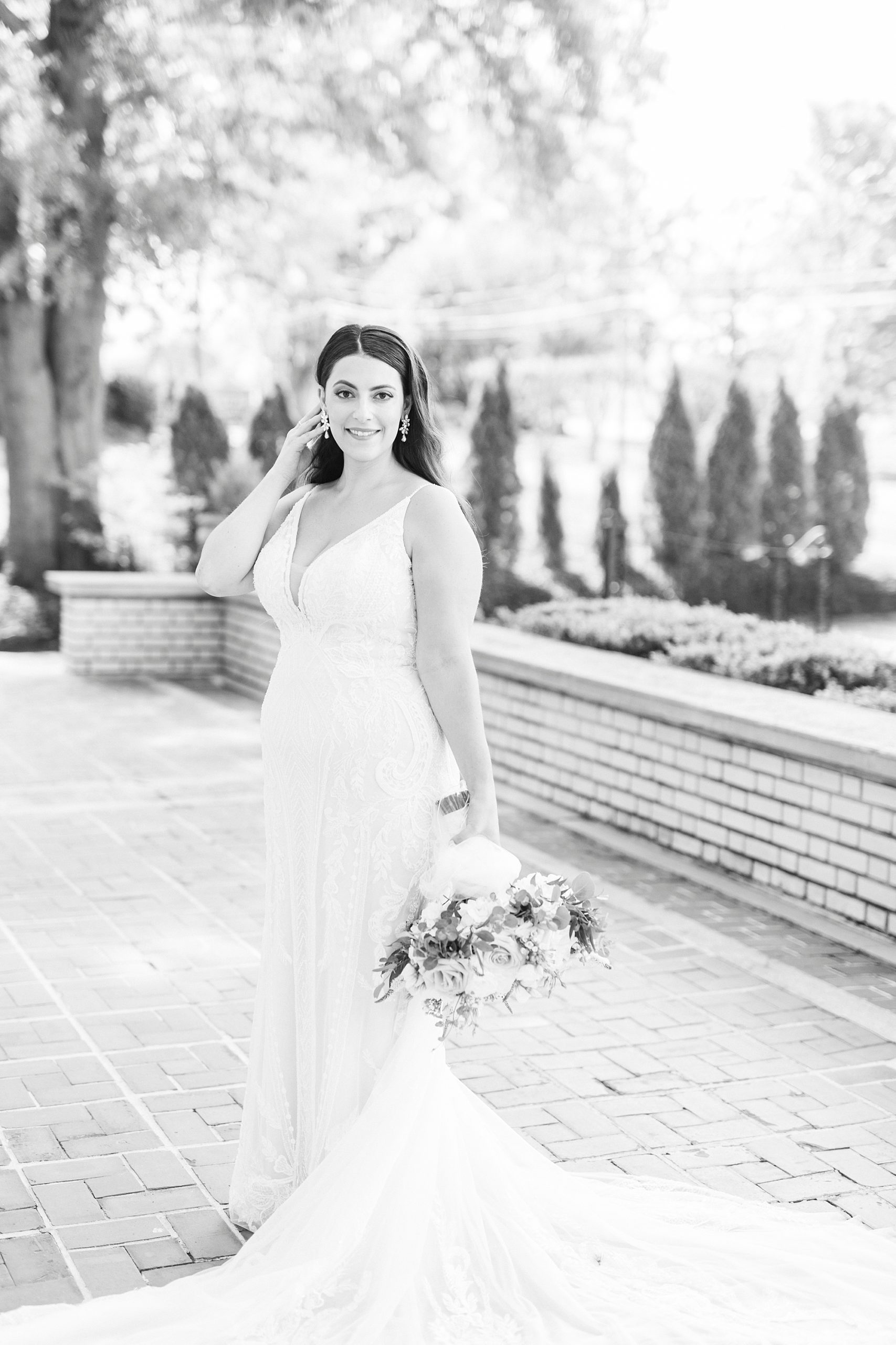 bride stands with bouquet down by her side on patio at Separk Mansion