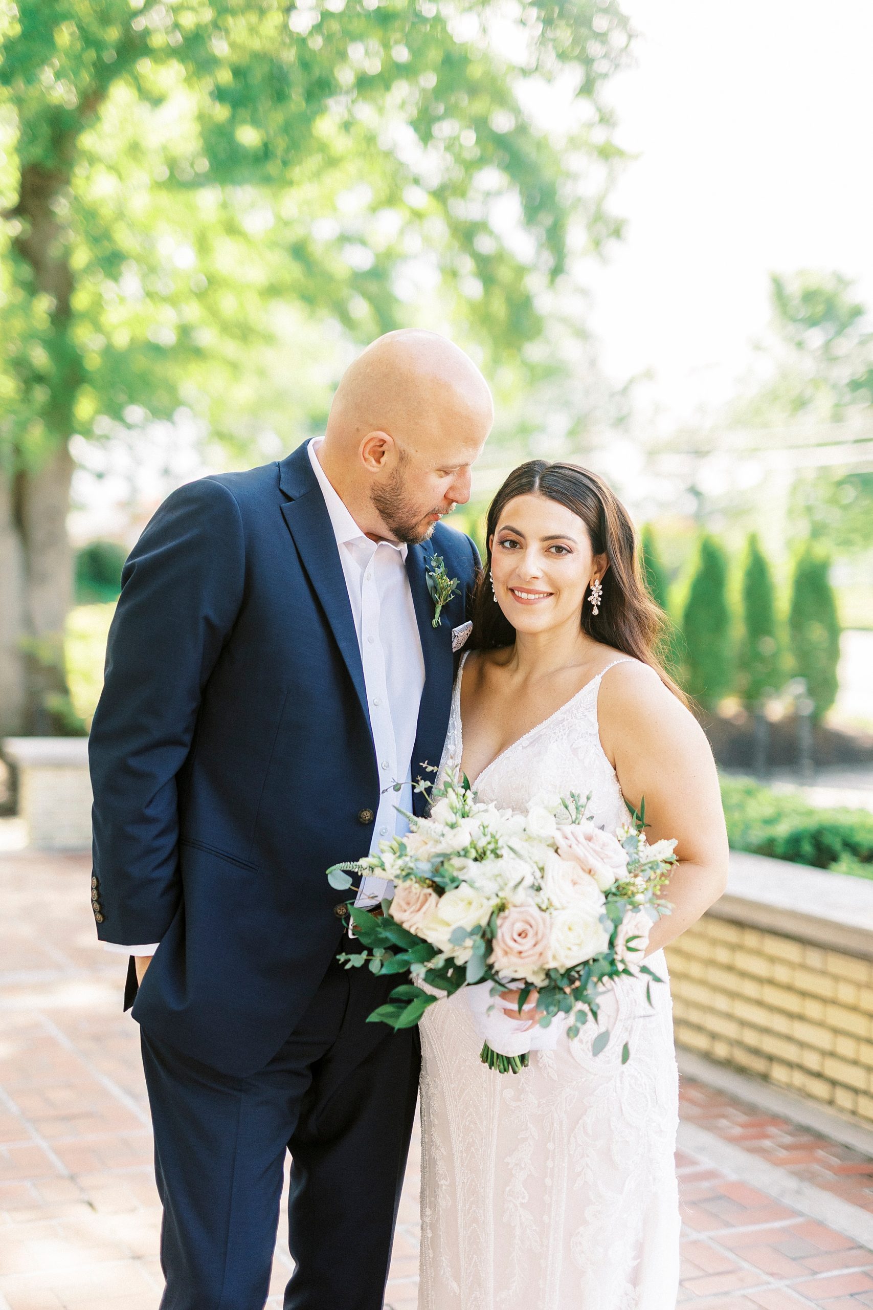 groom smiles down at bride during portraits in Charlotte NC