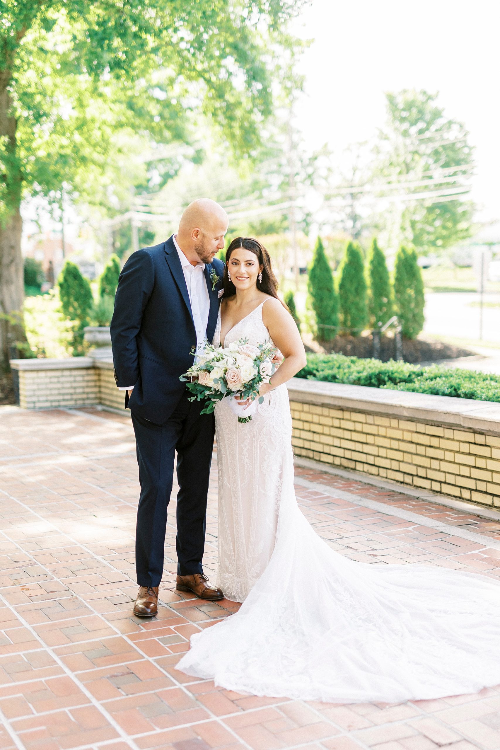 newlyweds stand together on brick patio at Separk Mansion