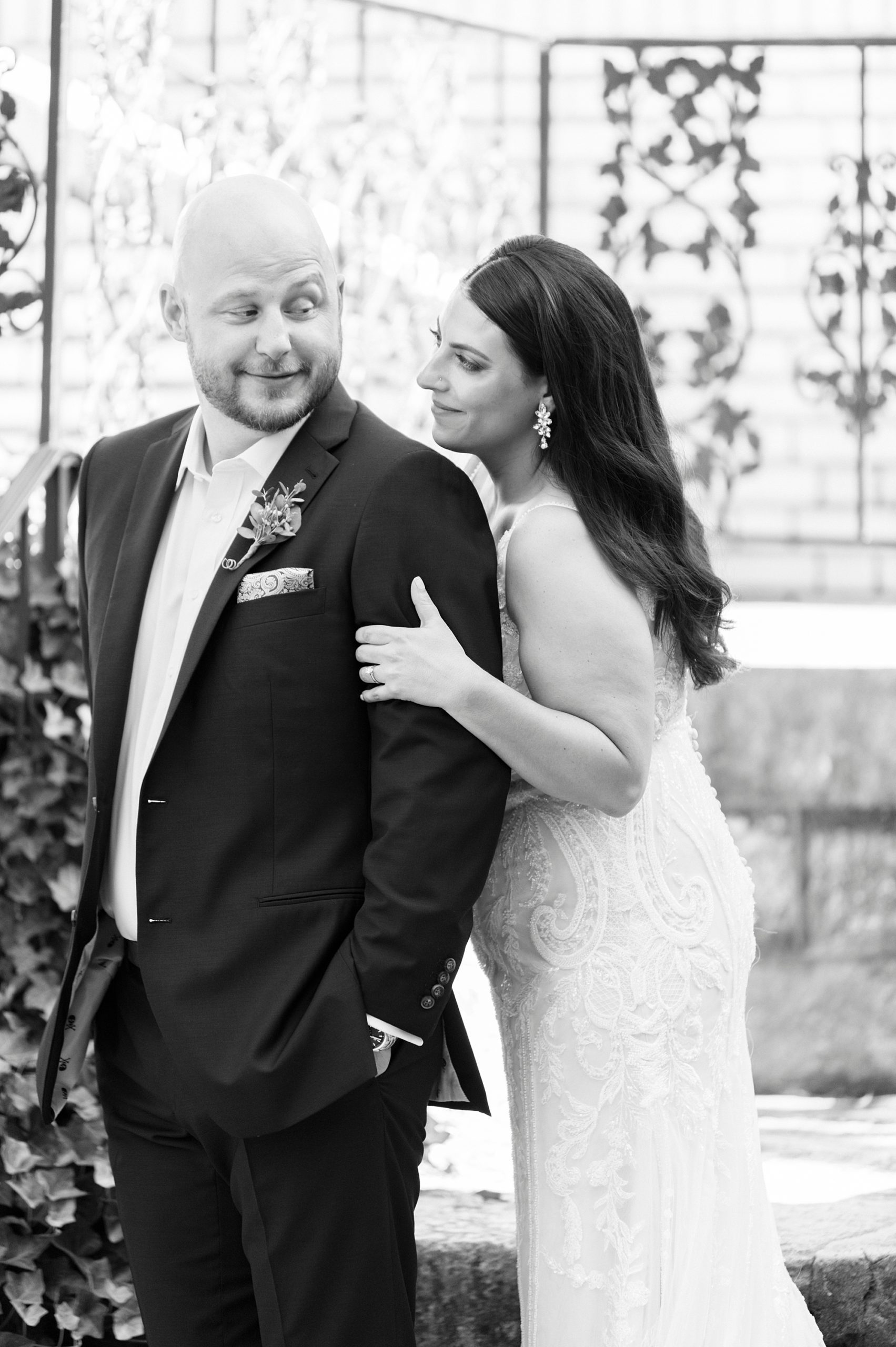 bride looks around groom's shoulder at Separk Mansion