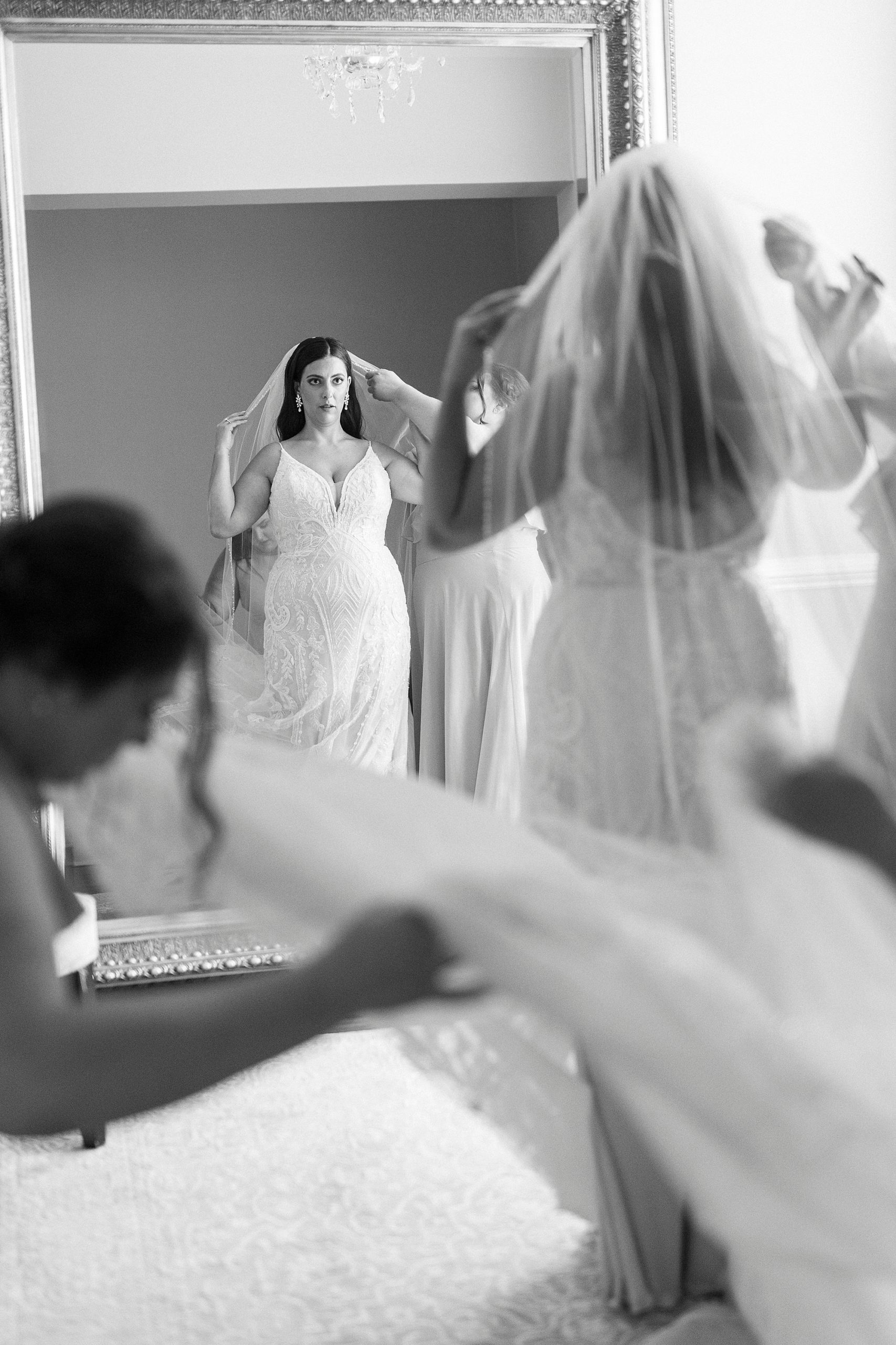 bride puts on veil before summer wedding at Separk Mansion
