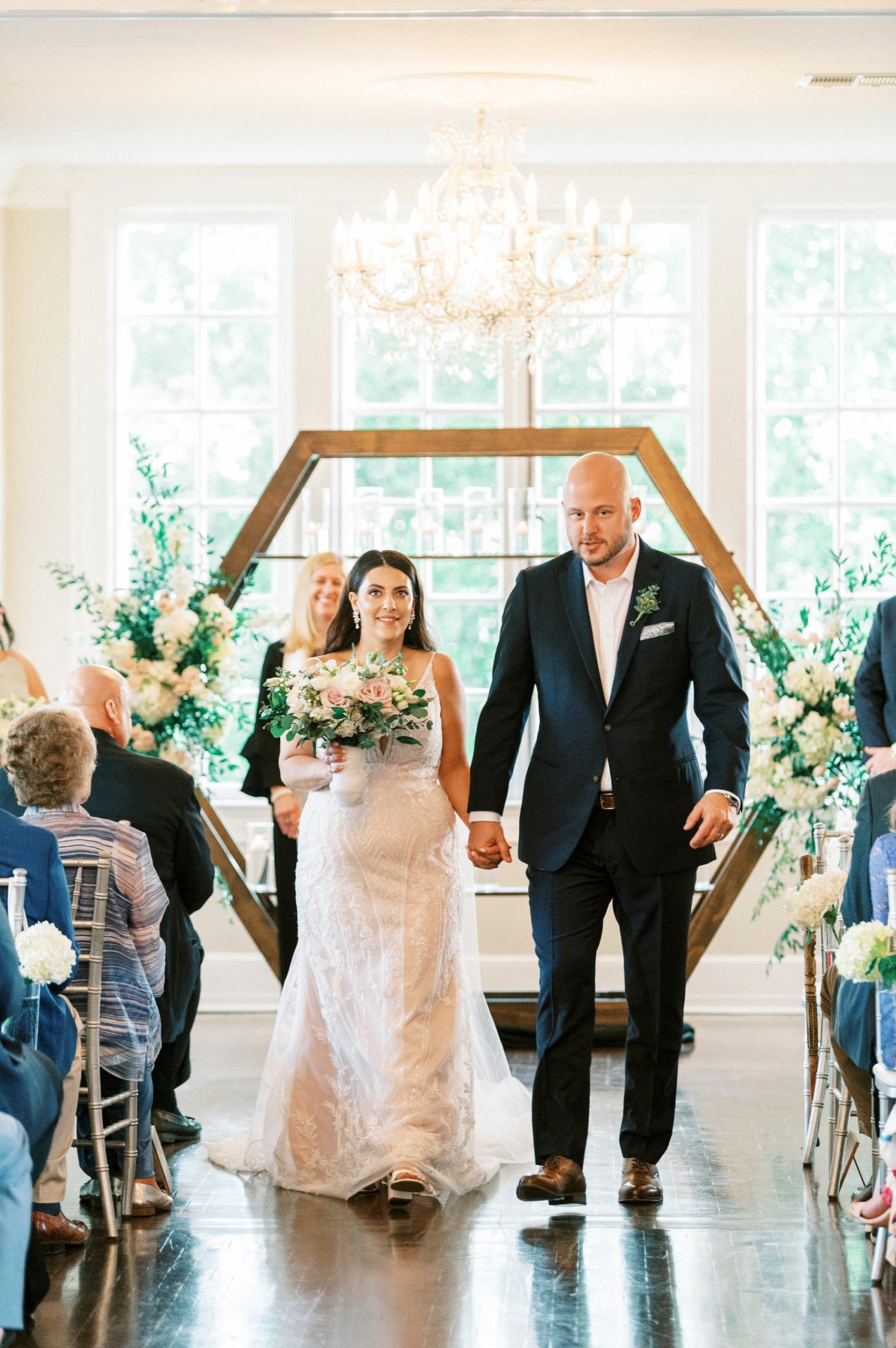 bride and groom walk up aisle after indoor wedding ceremony at Separk Mansion