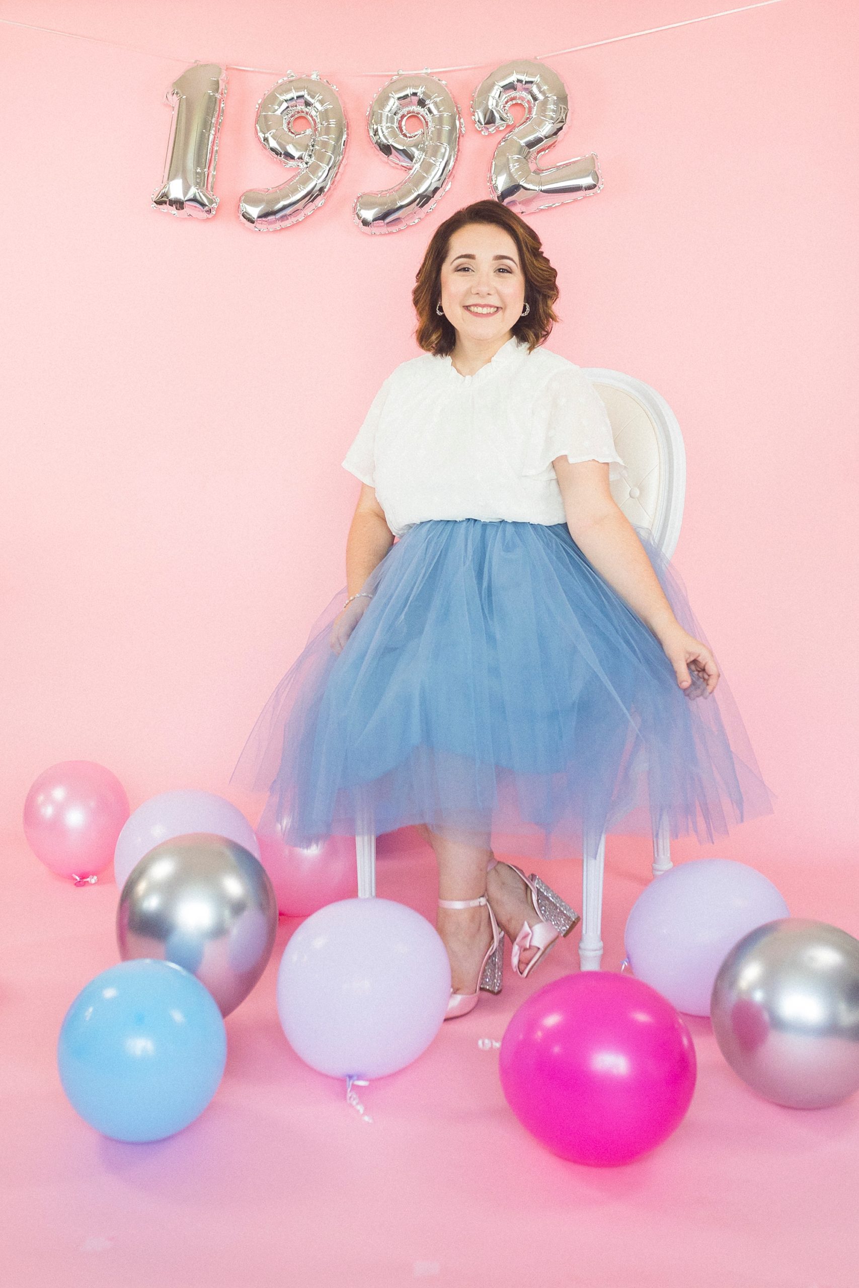 woman sits in white top and blue skirt for 30th Birthday Portraits
