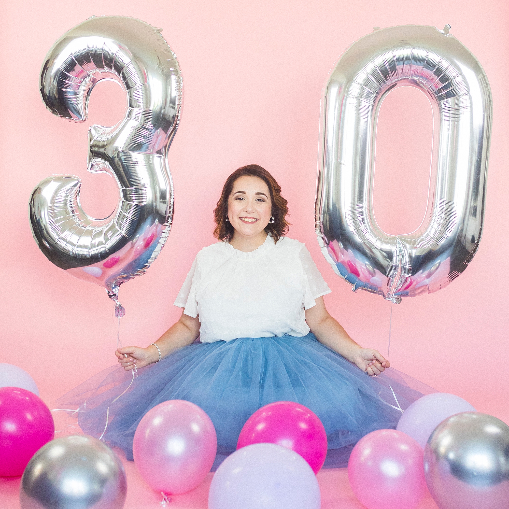 30th birthday portraits with big balloons and woman in blue skirt