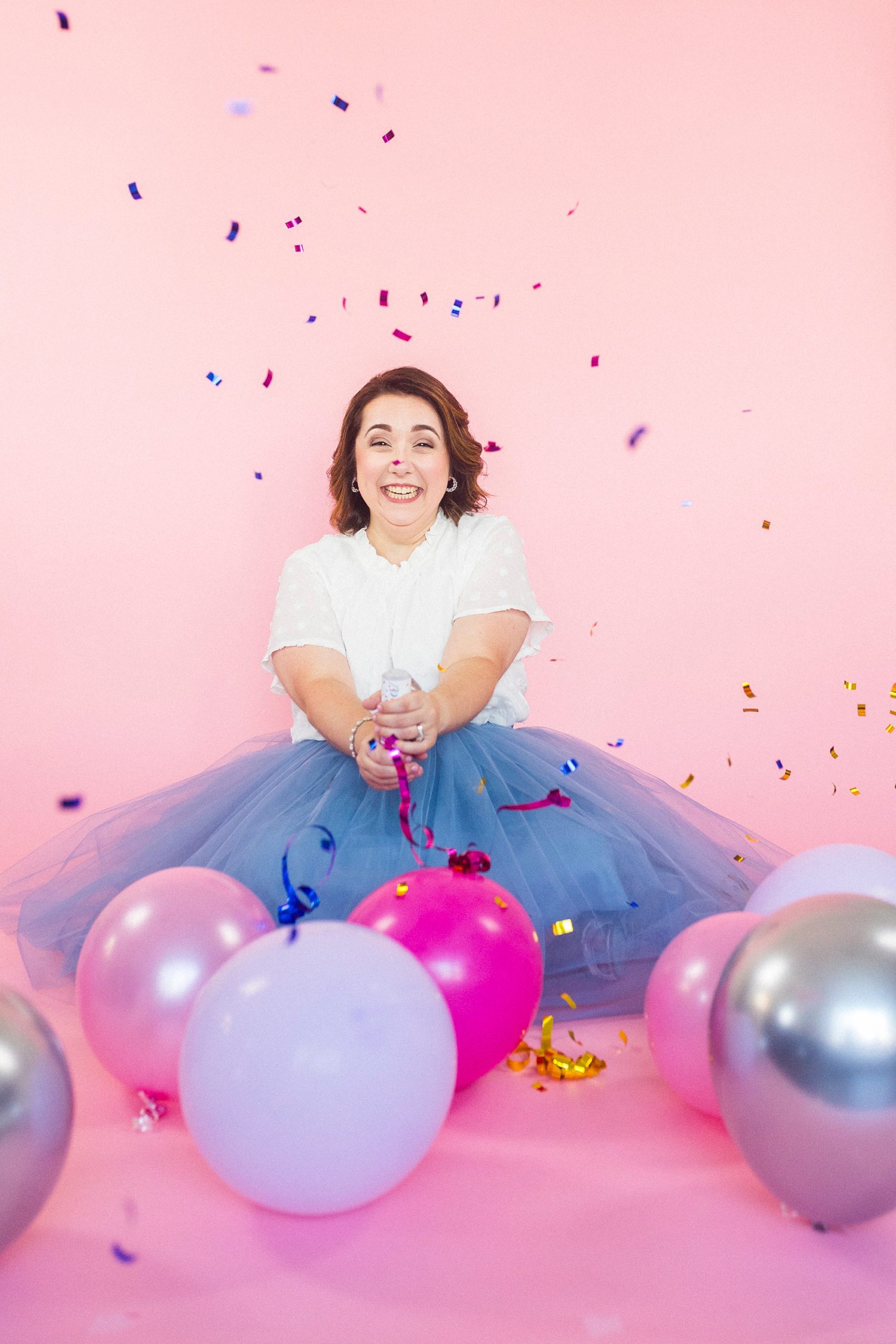 woman tosses confetti during 30th birthday portraits