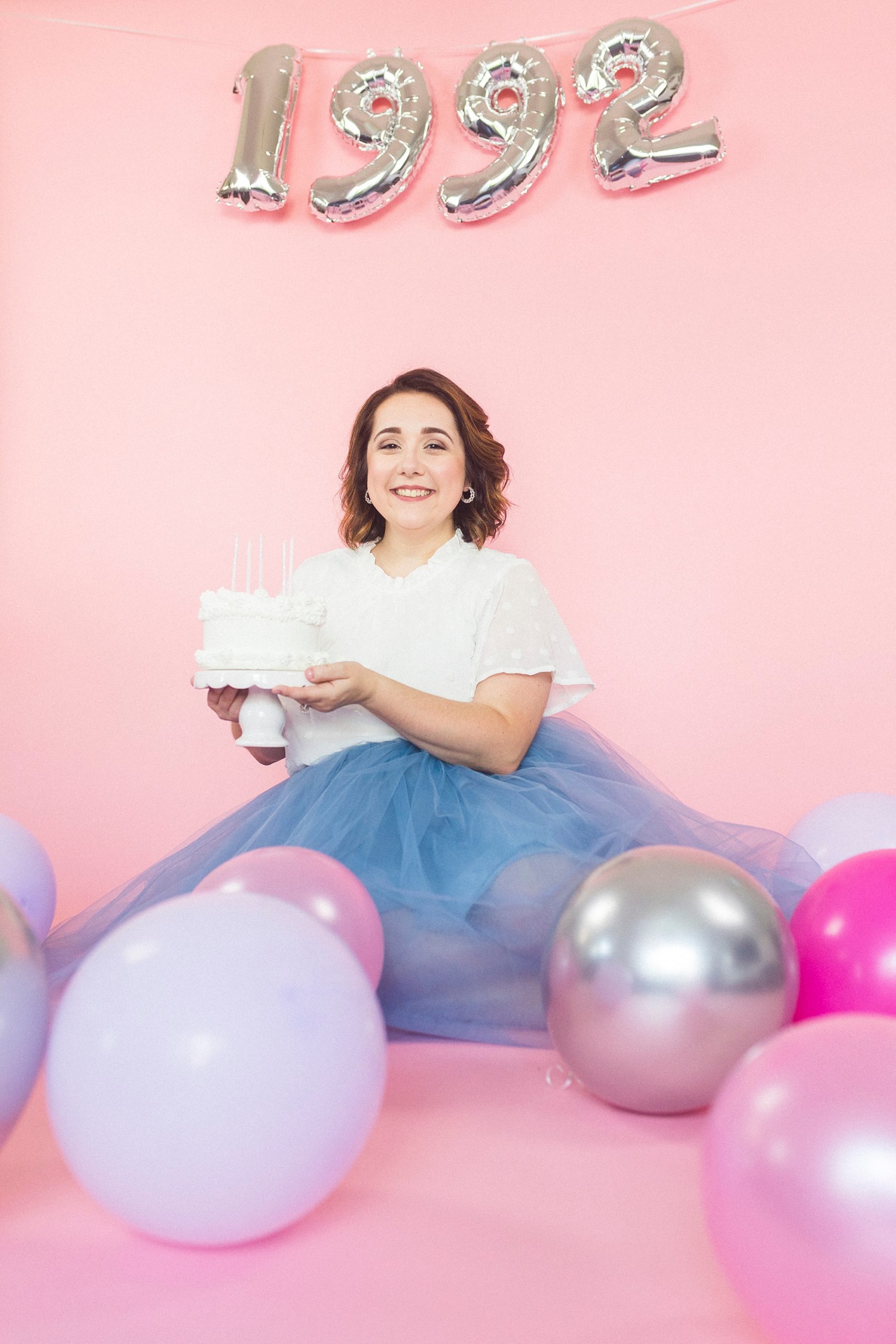 birthday girl holds cake during 30th birthday portraits 