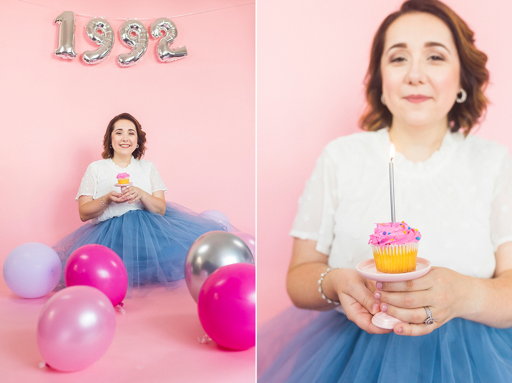 woman holds cupcake during 30th birthday portraits on pink backdrop