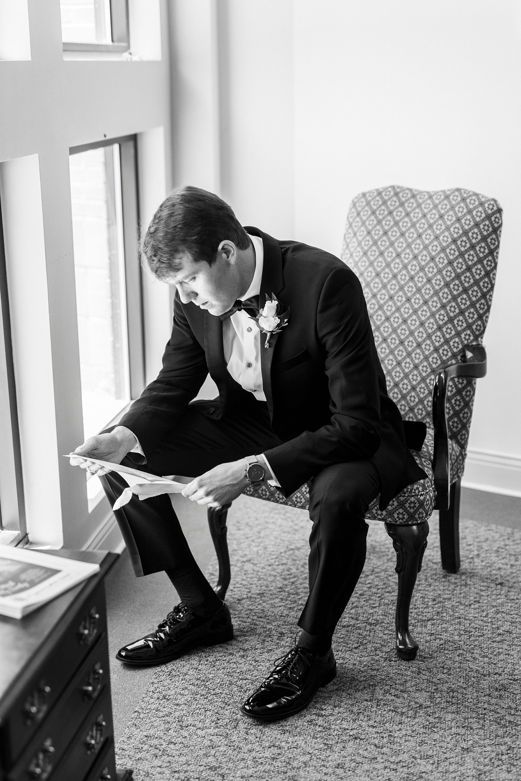 groom reads letter from bride on morning of wedding