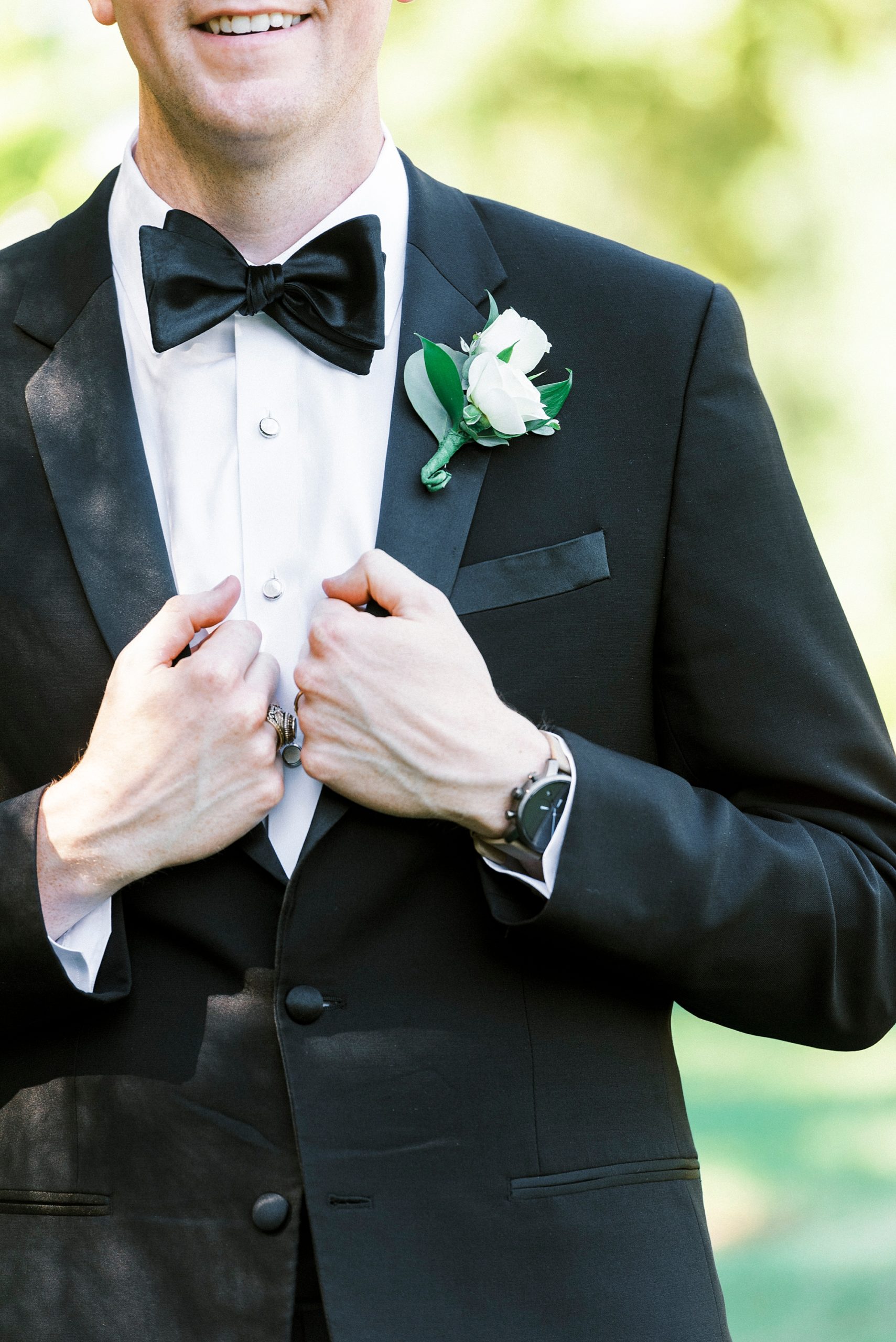 groom stands in classic suit jacket at Freedom Park