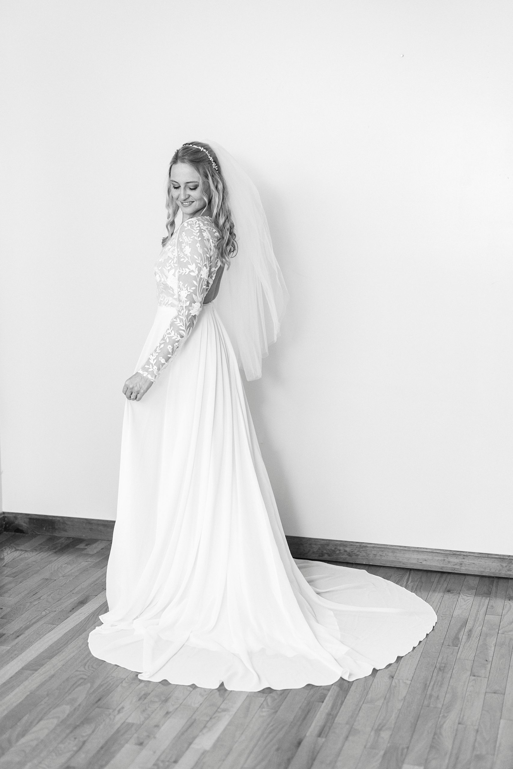 bride looks over shoulder of lace bodice