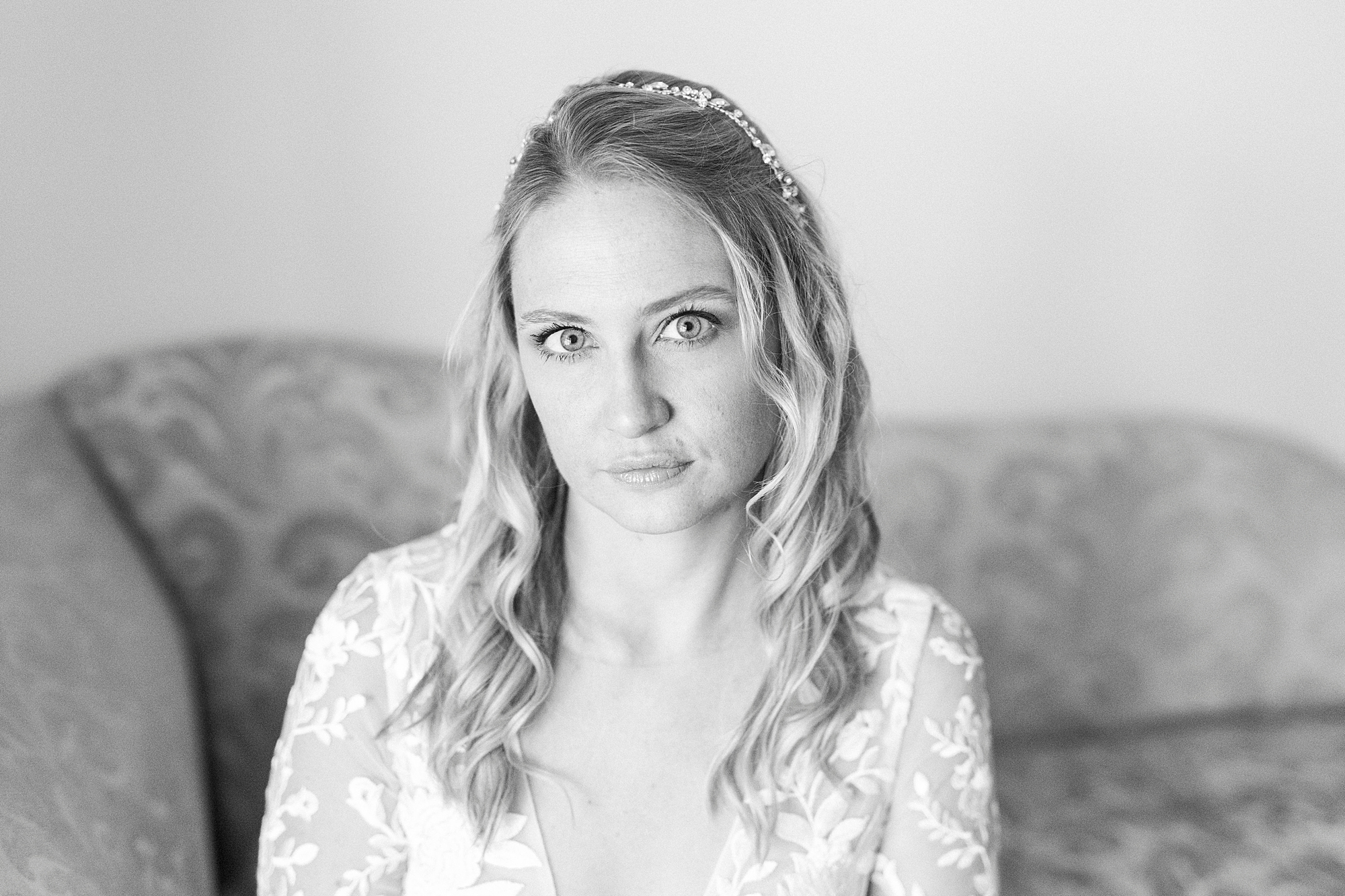 bride looks at camera during bridal portraits in lace bodice wedding gown