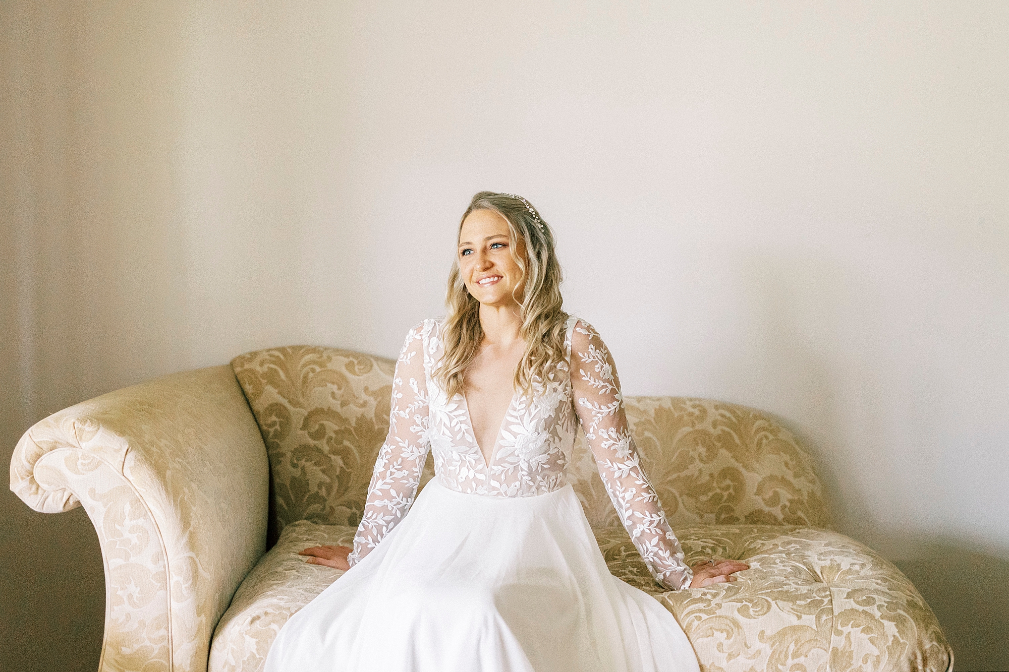 bride laughs during bridal portraits on couch in Lenoir NC