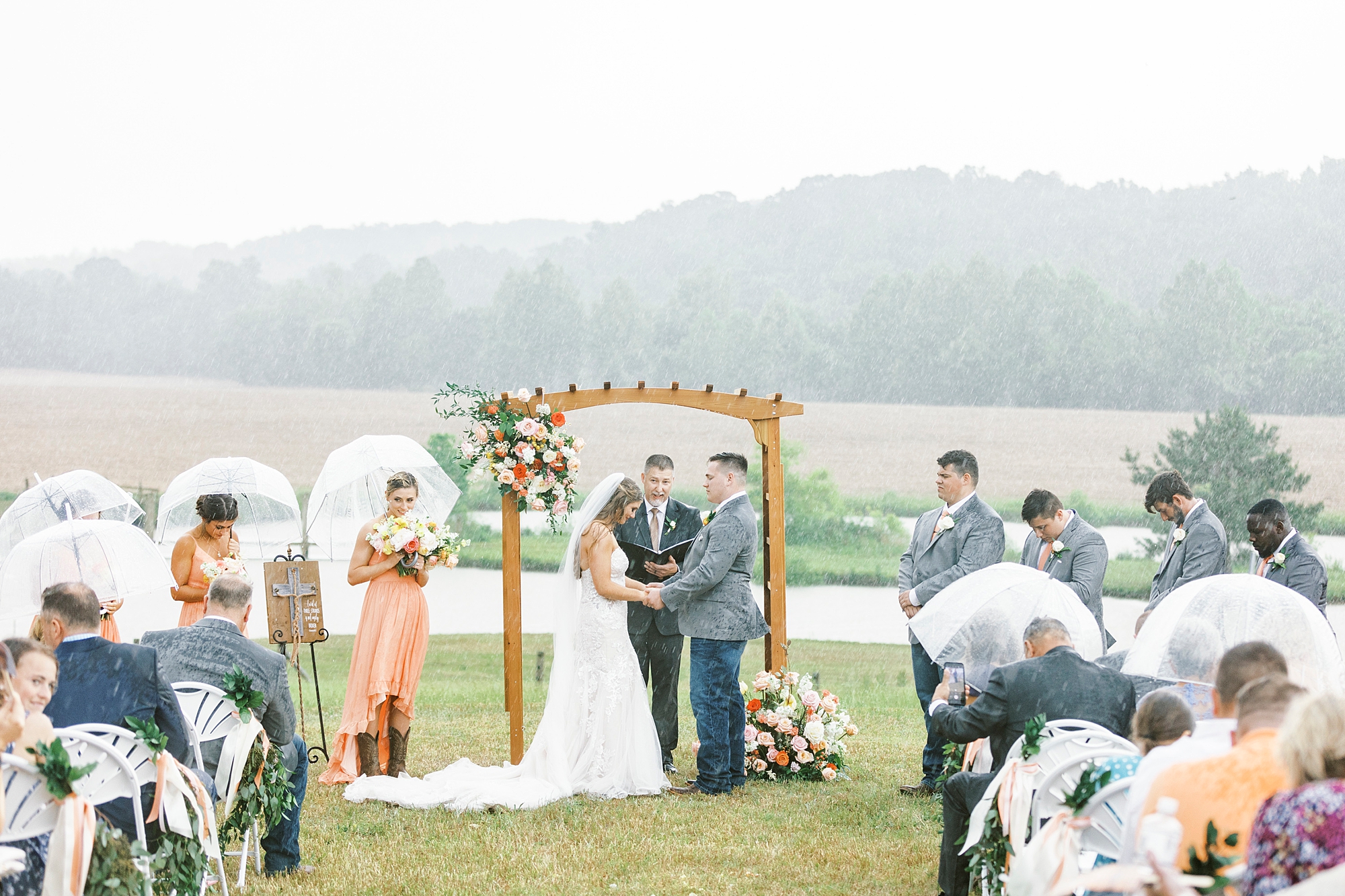 bride and groom exchange vows during rainy wedding ceremony at The Stable at Riverview