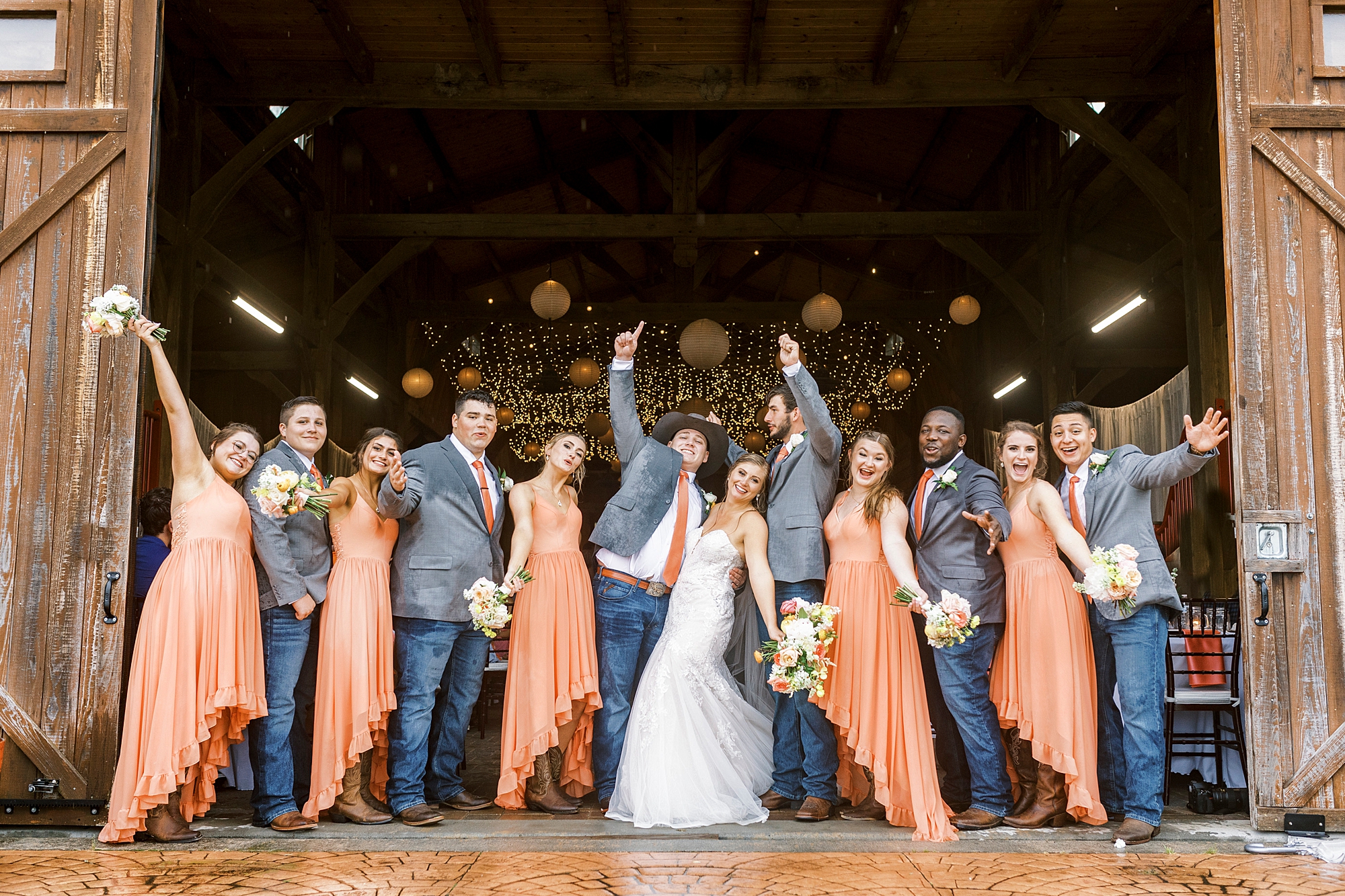 newlyweds cheer with wedding party
