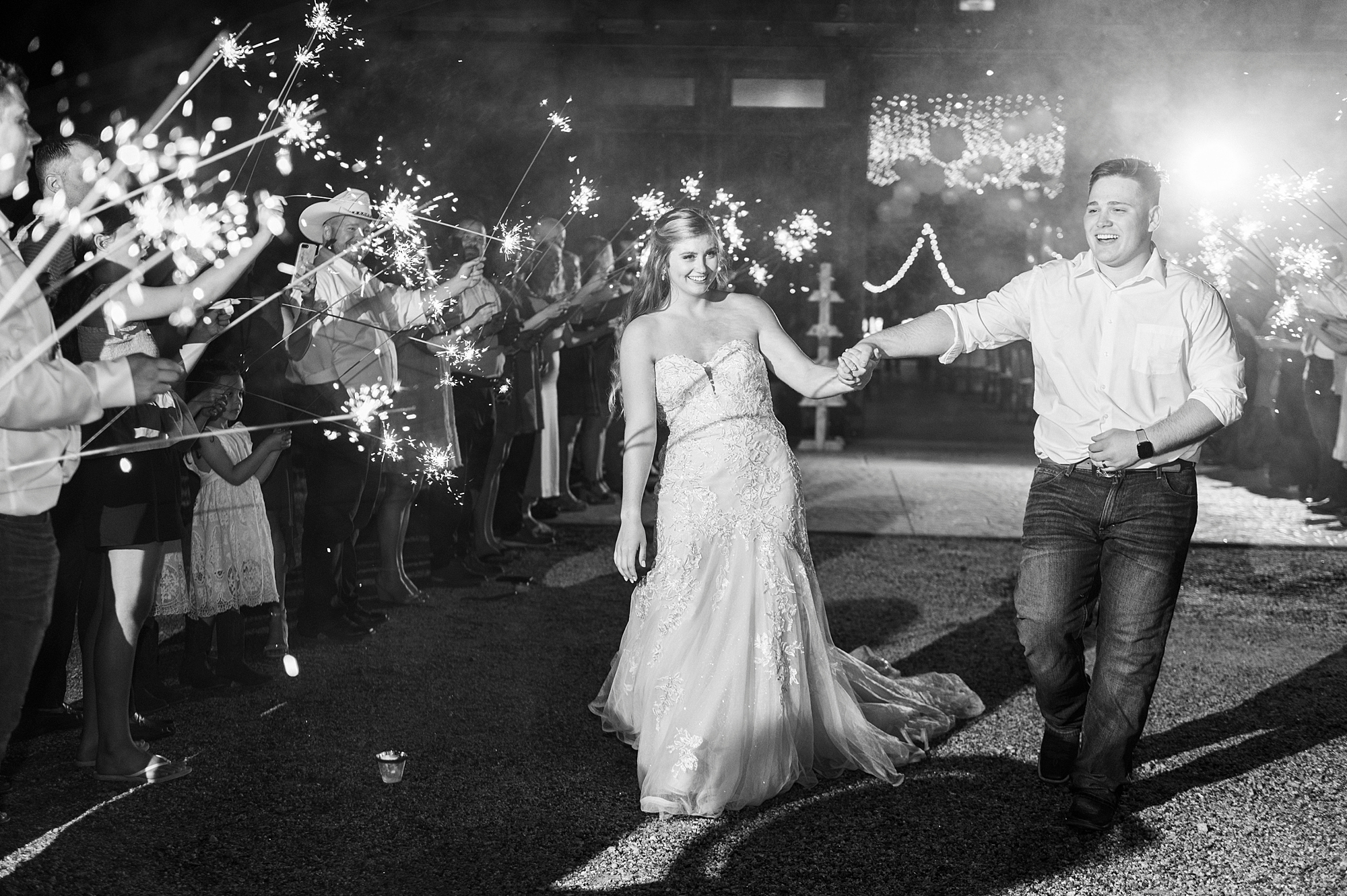 bride and groom hold hands leaving The Stable at Riverview