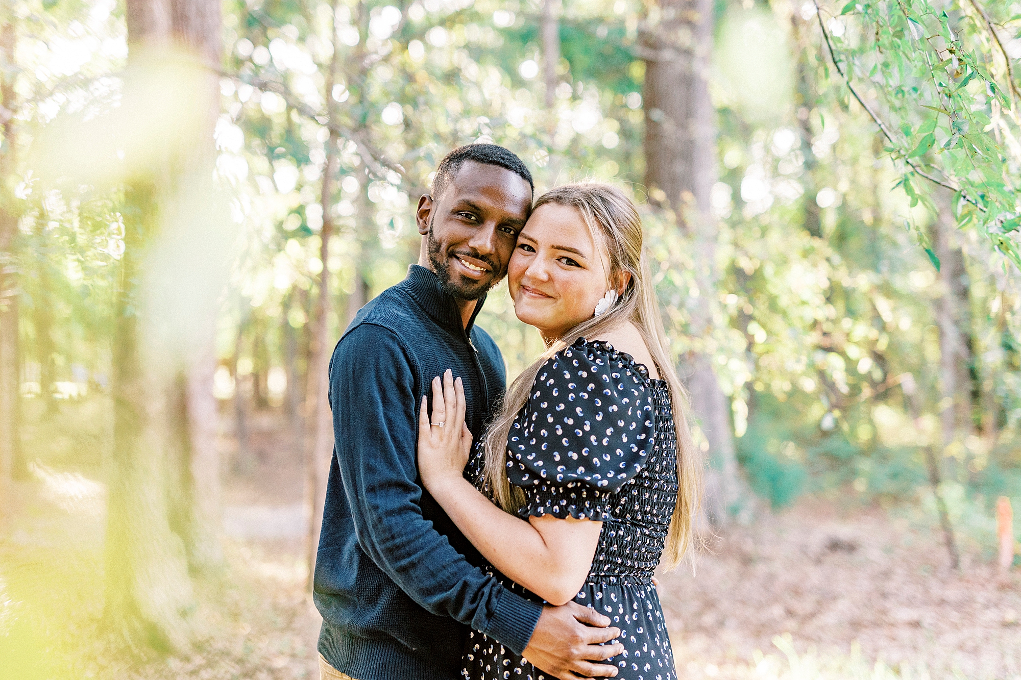 man hugs fiancee to him during fall engagement session