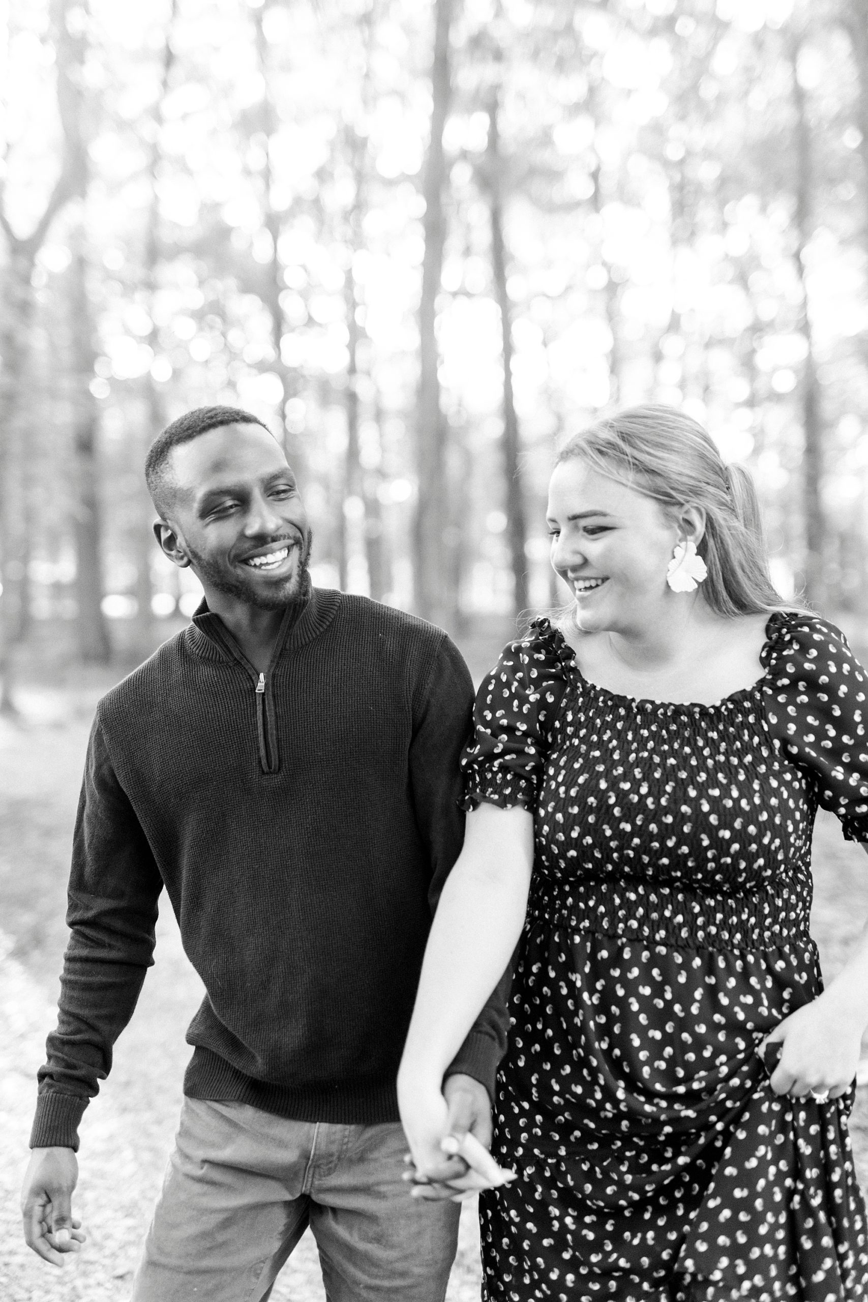 man laughs with fiancee during NC engagement photos