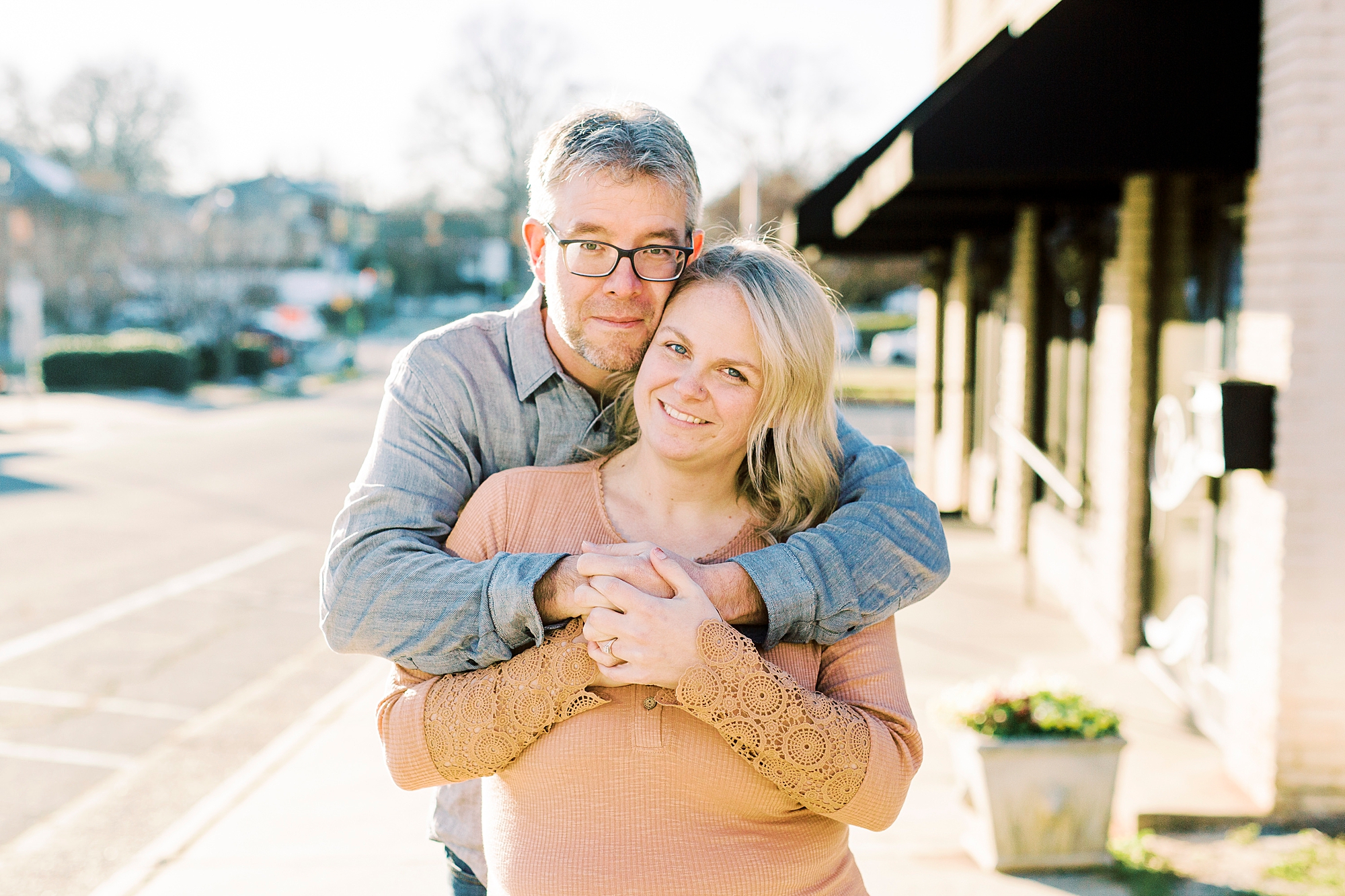 couple hugs during Downtown Monroe engagement portraits