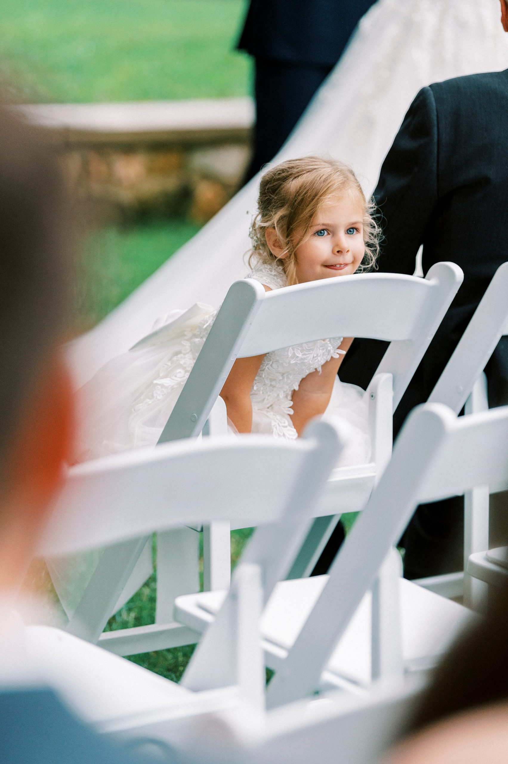 flower girl climbs on chair during wedding ceremony 