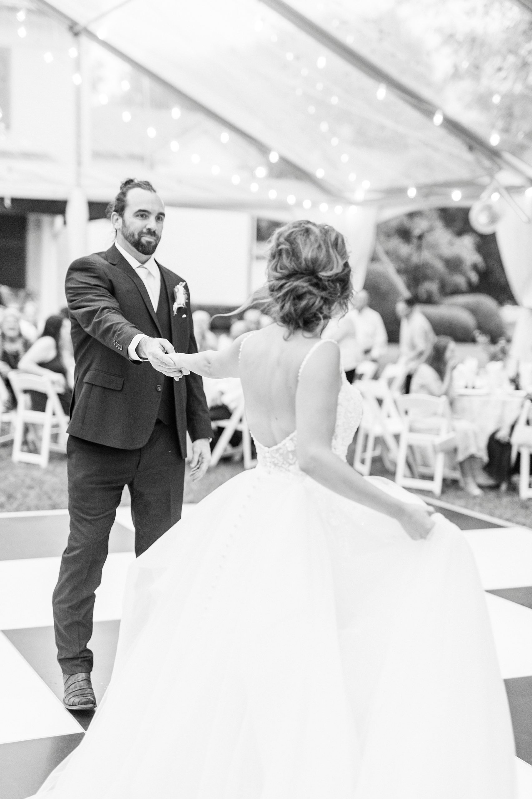 groom twirls bride away from him during dances